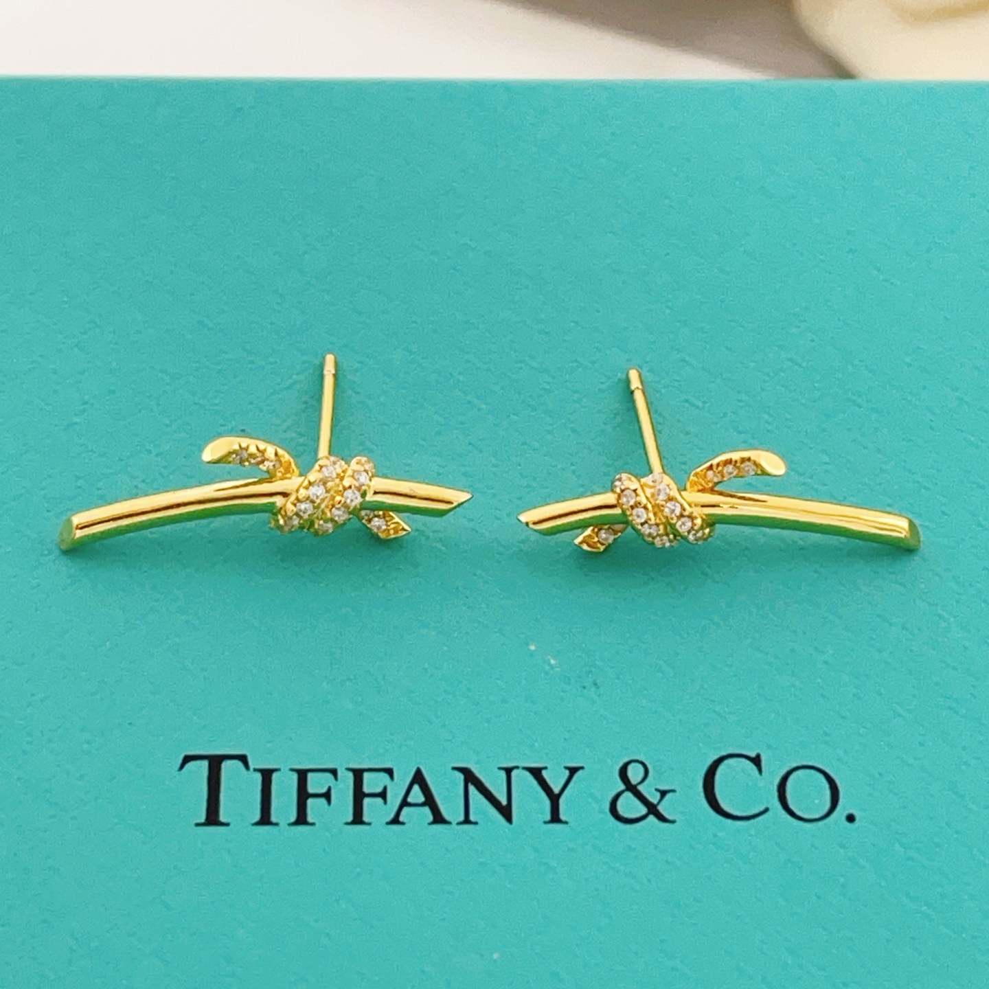 Tiffany Co Tiffany Knot earrings yellow gold with clear diamond accents 18mm bar length