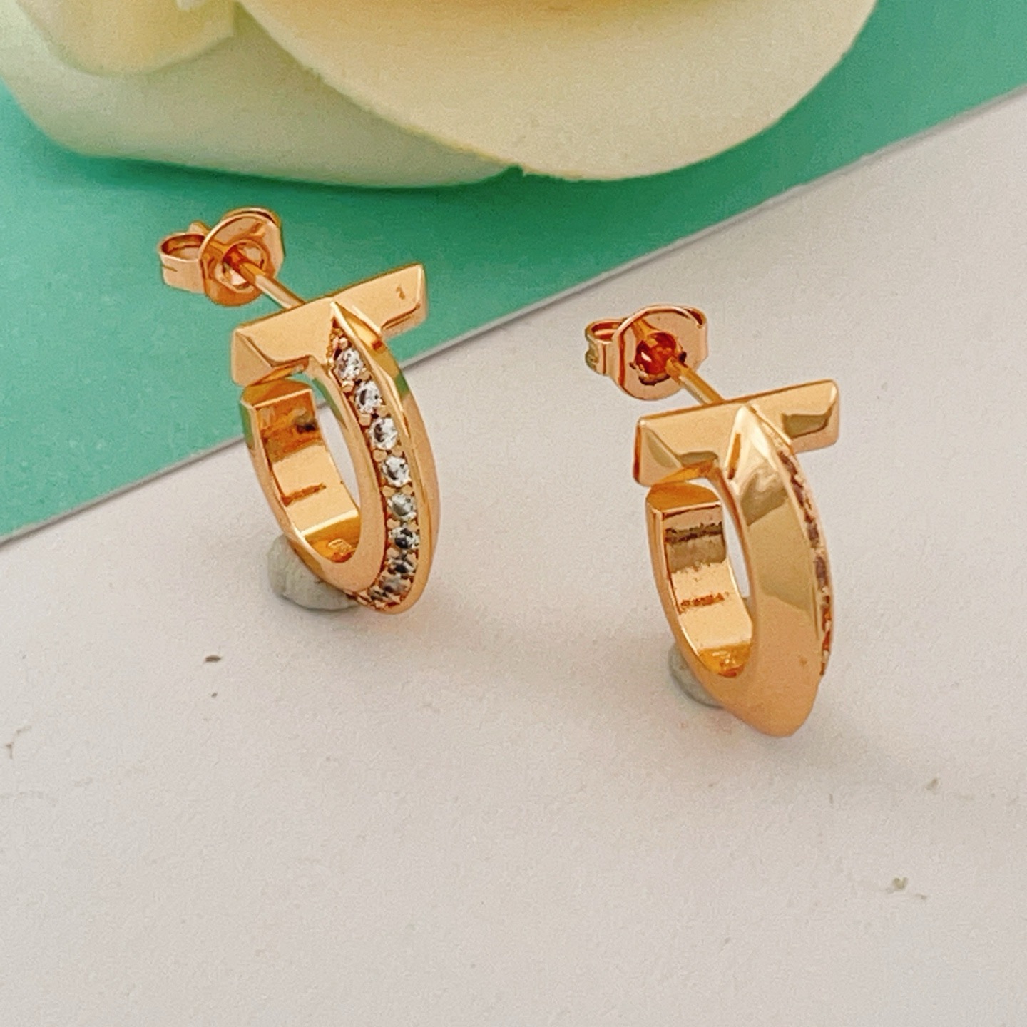 Tiffany T1 earrings rose gold metal with clear diamond accents 10mm hoop diameter