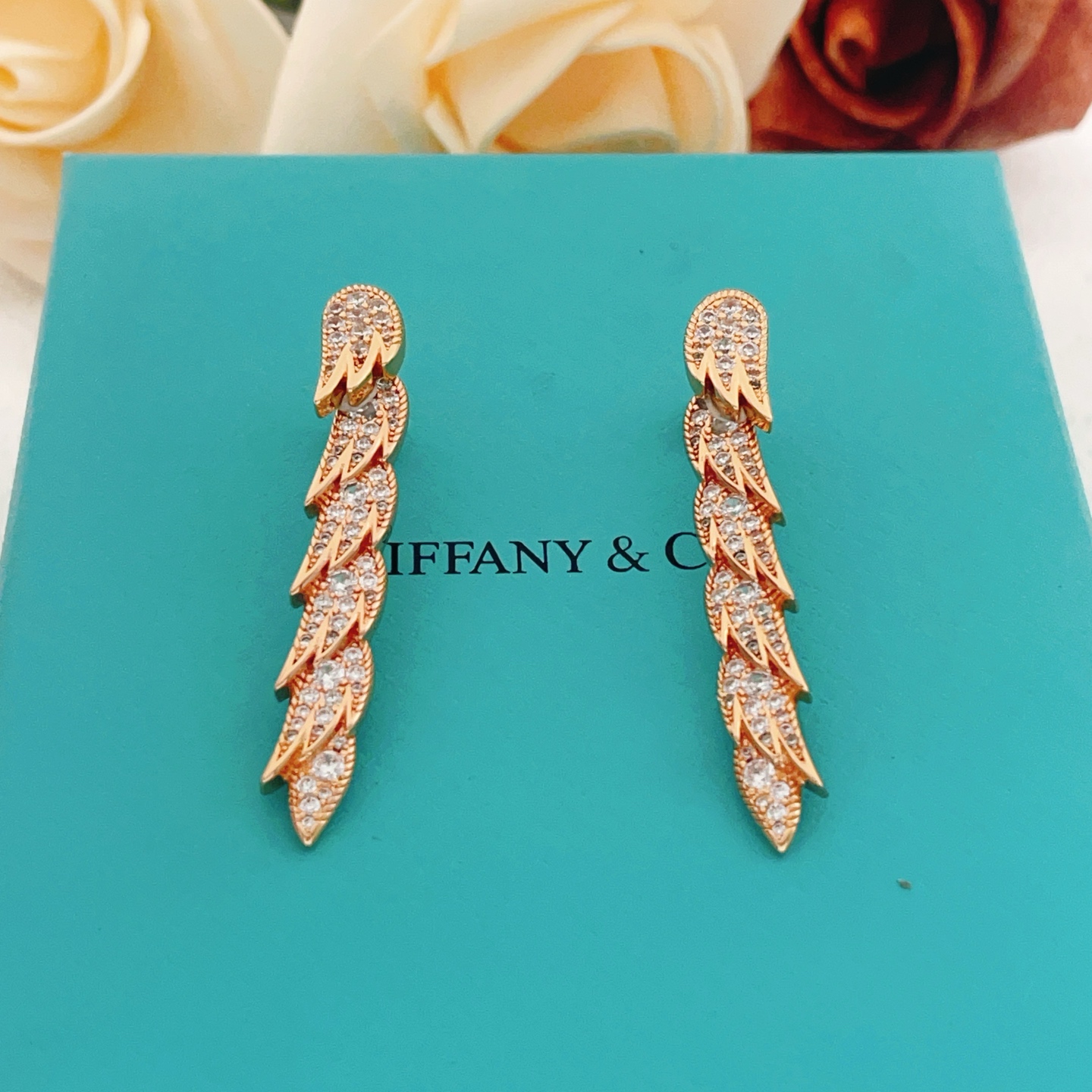 Tiffany Co Feather Drop earrings Rose gold metal with clear diamond-like gemstones 4 5cm length