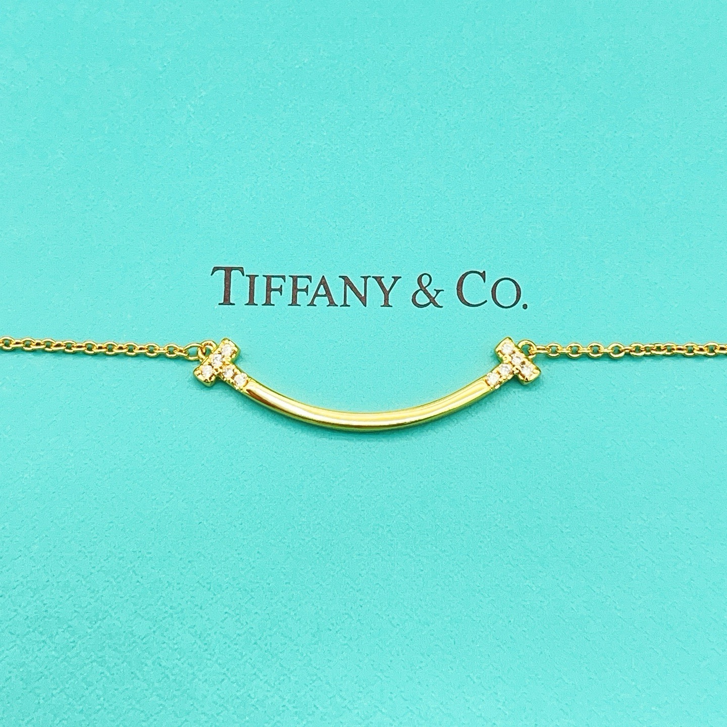 Tiffany Co T Smile necklace 18k yellow gold with clear diamond accents 16-18 inch adjustable chain
