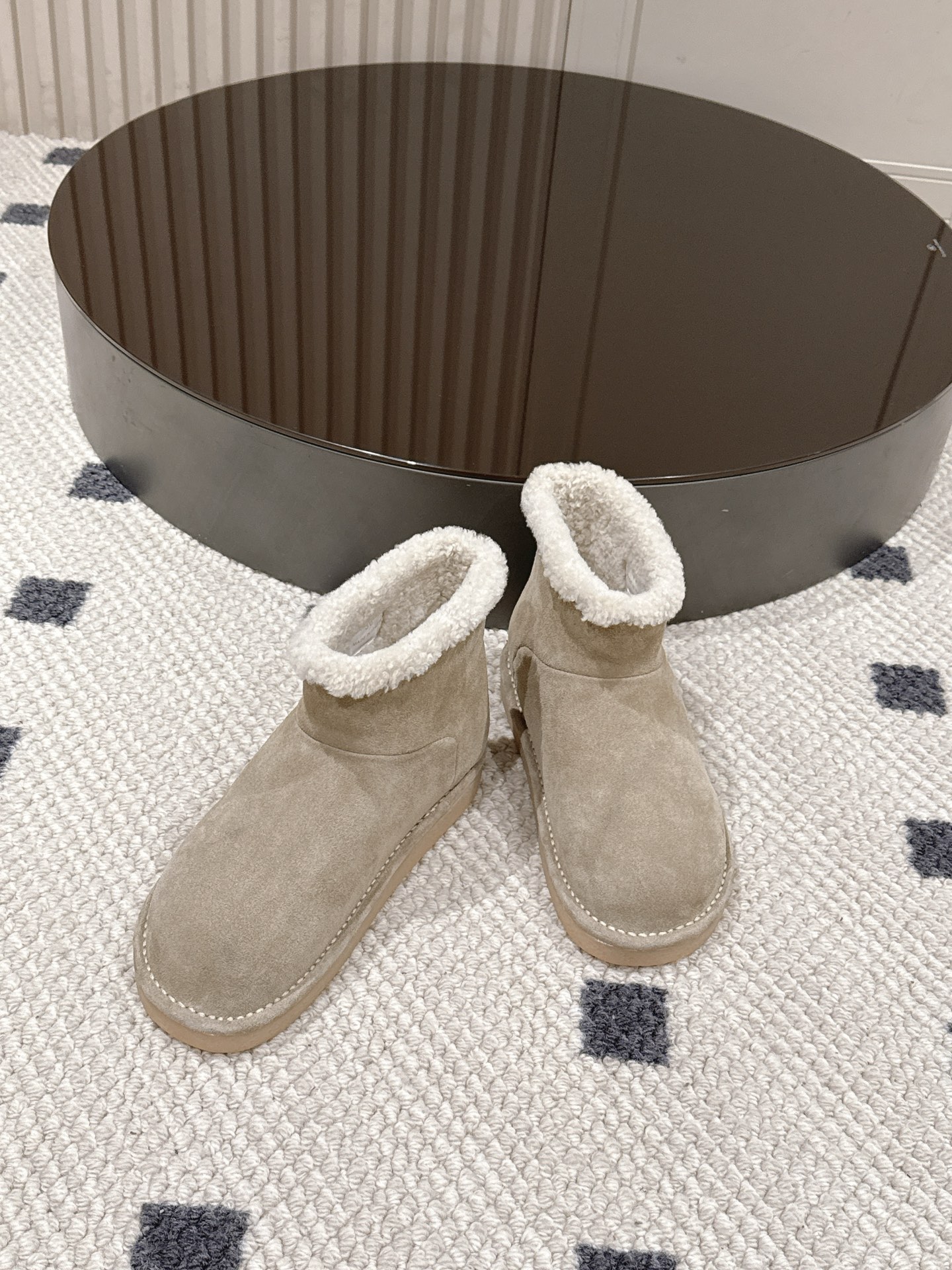 p280。码数35-40！
Miu Miu 25FW 羊毛雪地靴
这是一款雪地靴，有浅米色和深棕色和黑色等款式。外观上，鞋面采用质感细腻的反绒皮材质，鞋口处环绕着一圈蓬松柔软的白色毛绒，既增添了时尚感，又能很好地包裹脚踝，起到保暖作用。
搭配方面，浅米色款可与浅色系的牛仔裤、针织裙搭配，打造出清新温柔的冬日造型；深棕色款则适合和深色系的工装裤、毛呢裙组合，营造出复古又温暖的风格，无论是日常出街还是冬日通勤，都很合适。