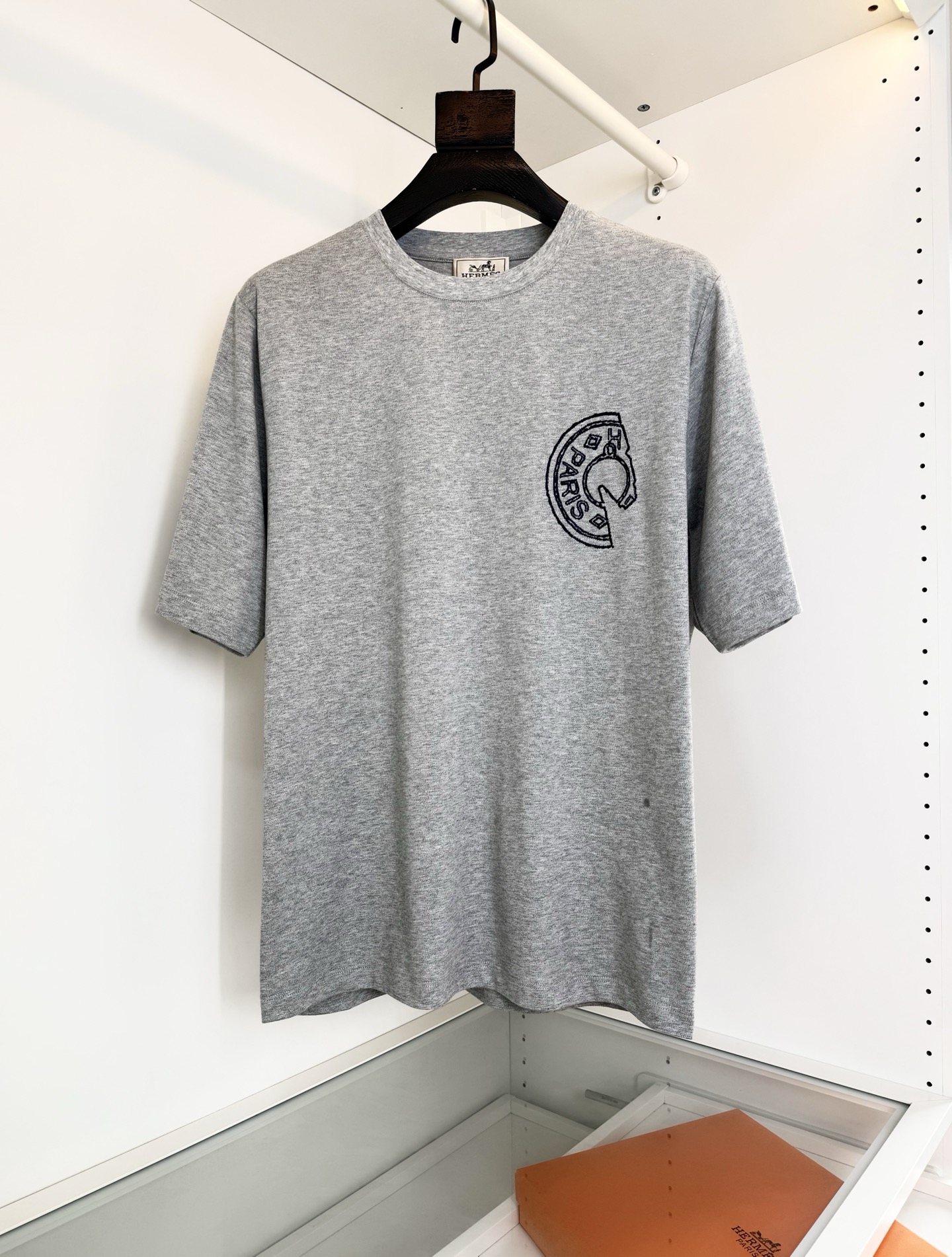 NO:781550,He*mès 2026 spring and summer, cabinets are on sale!  Saddle Nail Theme Slightly Wide Round Neck Short-Sleeved T-shirt Saddle Nail Theme uses embroidery technology to present the theme design. The upper body is fashionable and gives a modern atmosphere. The original slightly wide cut, the collar slightly fits the neck, making the overall upper body more youthful and fashionable. Before cutting, the fabric is strictly washed according to the standard of 5 times before dyeing, and the shrinkage rate is controlled within 2.  The fabric is made of custom-woven high-weight pure cotton, with a warm luster on the surface. The upper body is comfortable and smooth, high-end, skin-friendly, breathable, and has a good stiffness. Color Black Gray Size M-319860909爱*仕(He*mès) 2026春夏,柜在售！ 马鞍钉主题微阔圆领短袖T恤衫 马鞍钉主题 以刺绣的工艺来呈现主题设计 上身时尚而赋予现代气息感 原版微阔的剪裁,领口微微贴合颈部,让整体上身更显年轻时尚 , 面料在裁剪前,严格按照染色前5次 洗水的标准, 将缩水率控制在2内, 面料采用客供定织高克重纯棉质地,表面有着温润的光泽感,上身舒适顺滑,显高档 亲肤 透气,又有很好挺括感 颜色 黑色 灰色 码数M-3XL 试穿172-148 穿L码合适,爱马仕-服装,hermes,T-shirt,tees，t-shirt,,Women's clothing