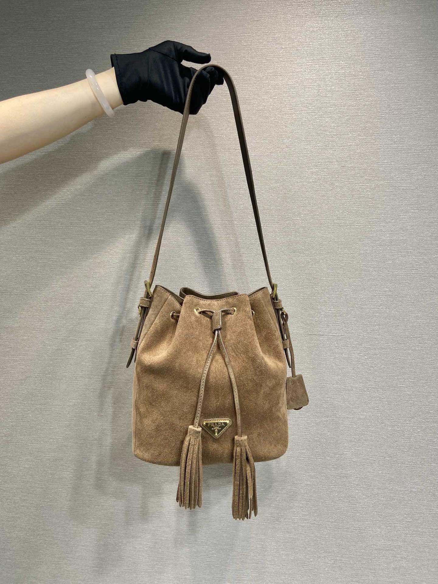 Prada Suede Bucket Bag with Tassel Drawstring Closure - Stylish & Versatile