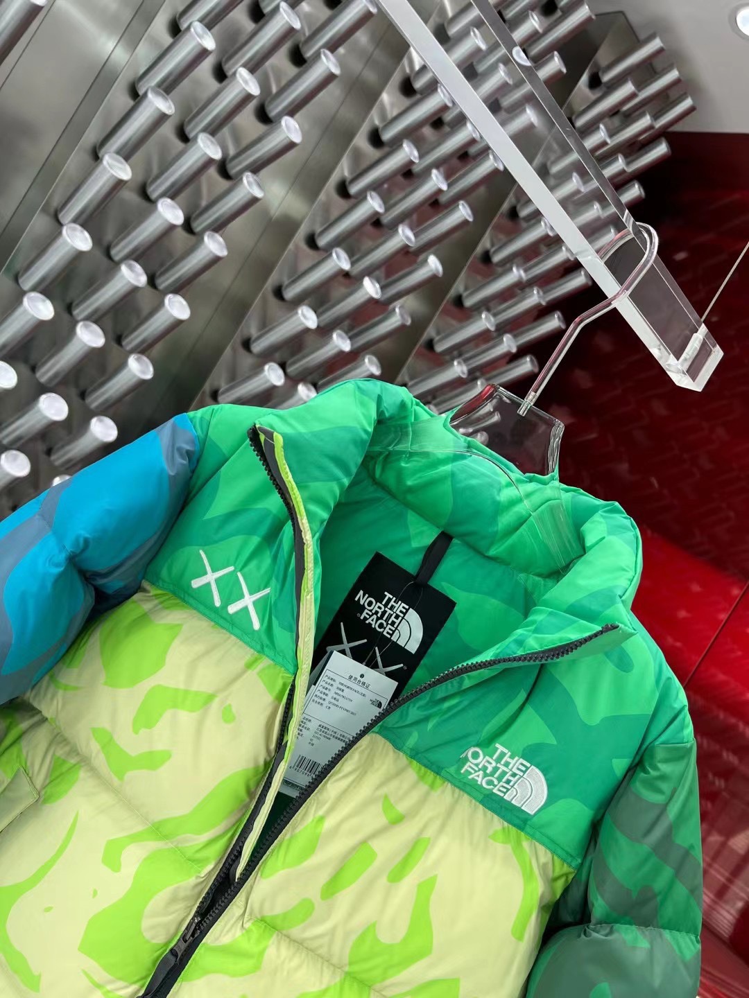 North Face x KAWS 1996 Nuptse jacket. New design with bold KAWS patterns and vibrant colors. Available in green and gray, sizes XS to XXL.-Big cat