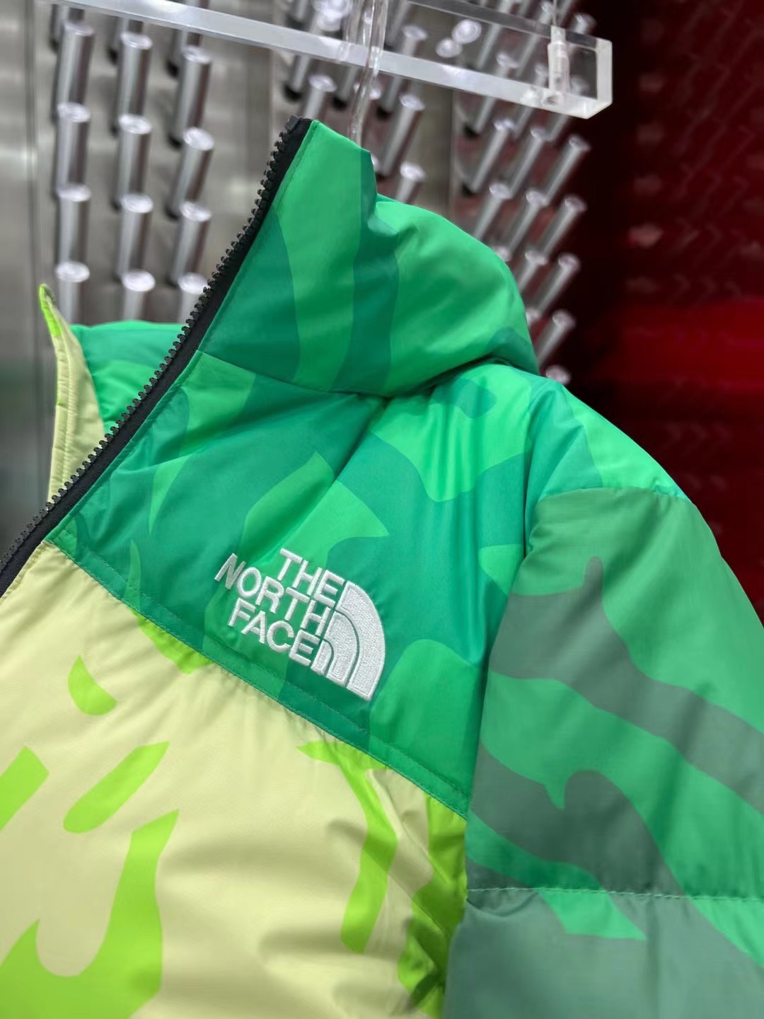 North Face x KAWS 1996 Nuptse jacket. New design with bold KAWS patterns and vibrant colors. Available in green and gray, sizes XS to XXL.-Big cat