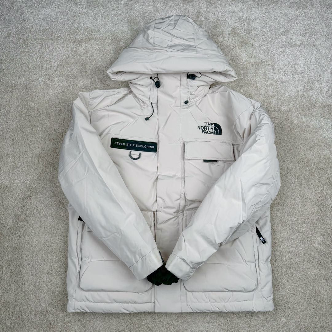 图片[2]-北面THE NORTH FACE POLAR FW22 纯色Logo徽标多口袋抽绳厚款连帽工装羽绒服冬季 男女同款 申敏儿同款 设计理念： 这款是THE NORTH FACE 巅峰之作，高端于任何一款北面羽绒服，也是户外的登山系列，爆炸厚实，一般是在户外极寒天气穿着，基本上可以抵御零下几十度的严寒了，工艺十分复杂，并非单纯一件羽绒服那么简单，保暖程度不输大鹅，今年冬天一定需要这样一件厚实的过冬。 面料+特点： ✅ 内里填充90%正品一致的进口专用鹅绒，轻便，100%市面最高品质。 ✅ 采用经联盟RDS认证的高品质鹅绒填充，轻便不厚重且压缩后的蓬松度恢复性好。（ R·D·S不含任何不必要的动物伤害生产工序，从550蓬到950蓬不等，压缩性和温度重量也是衡量高品质，高填充度鹅线要指标） ✅单件成品1公斤以上，但是没有任何负重感，超级轻便，鹅绒广泛用于滑雪服，防寒服。 ✅原厂高密度户外防水材质，防风耐磨，防撕裂面料。 ✅ 里布380T最高标准，绝不跑绒，透气性极佳 ✅ 原版辅料五金全部原厂定做，100%还原复刻品质！ ✅多功能口袋，方便使用 ✅内里两侧印有保养清洗说明和衣服解释 ✅胸前贴饰有橡胶徽标logo ✅领口部分有防寒绒布，紧贴头颈，舒适又保暖 ✅ 原版辅料五金全部原厂定做，100%还原复刻品质，背部有内置网口袋 ✅ YKK吉田ISO9000品质顶级ZP拉链 工艺： 宽松版型，上身休闲舒适，为冬季户外提供保暖呵护，保暖性出色，穿着轻便不厚重。防潮,不易变形 ，容易清洁打理等特点，工艺成本极高 ​-选品中心