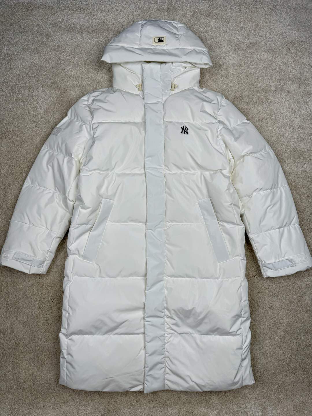 ＃暖冬福利 𝐌𝐋𝐁 纽约洋基队𝐍𝐘 小标刺绣LOGO长款连帽羽绒服 三标齐全、男女同款、加厚保暖、下雪的城市、直接入它！ MLB是韩国F&F旗下潮流服装品牌，拥有150年历史的经典传统，是街头文化和国际生活方式的领导者。MLB 拥有包括男装、女装、童装、配饰 在内的全品类服饰，提供覆盖各性别、各年龄层、From HeadtoToe的穿搭装备。其产品结合了韩国的时尚造型与质感，展现了运动服饰也可以兼具时尚潮流的风格。在产品设计上，MLB不仅融合了美国职业棒球大联盟的各当家球队，更结合了棒球运动中的各个元素。 采用国标80%白鸭绒，独家使用正品同步羽绒 正品同步面料： 100% 锦纶; 里料： 100% 锦纶 原厂定制电镀五金辅料，非市场各类复刻版！市面最顶级没有之一。 配色：黑色 白色 尺码：XS-XXL-选品中心