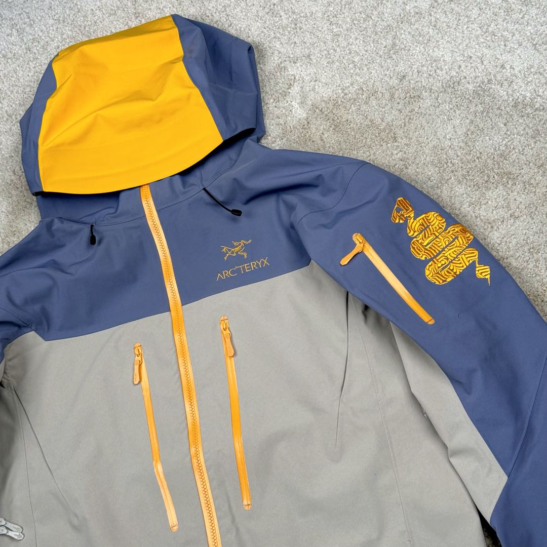 图片[9]-＃TZD Arcteryx Alpha SV 7 GORE-TEX Pro 始祖鸟第七代刺绣Logo图案休闲运动连帽拉链硬壳户外远足防水冲锋衣 蛇年限定 台州顶级批次 现货供应众所周日每年始祖鸟都会以十二生肖为思路出一款联名款的新年限定，今年也不例外此次的蛇年限定胸口logo为金标衣袖上的蛇形图案也很吸睛帽子上还有蛇鳞为点缀整个衣服的颜色为金黄-深蓝-棕整体看上去很亮设计感拉满 颜色搭配也很好! – Alpha SV JACKET 硬壳限定款Alpha SV JACKET 在袖口和内侧口袋饰有蛇形图案， – 限定款的帽子边缘同样点缀着蛇鳞印花设计 蛇“名”所代表的坚韧精神，正如始祖鸟高山精神所倡导的无畏挑战、勇往直前。 NO1. 防水：防水为国际ISO标准90(ISO4)级别达到荷叶水珠滚动效果! NO2. 面料：采用2L双层Gore-tex面料，面料表层做超高强度防水，内层覆膜，所以到达三层防水的效果，使成衣具有防水防污透气的出色效果。 NO3. 工艺：压胶采用的胶水为铁金刚胶条，市面销售的潜水服就是这个牌子的胶水，区别市面普通压胶(洗几次就开胶)咱家只管放心 NO4. 刺绣：进口百灵达刺绣机还原ZP。百灵达刺绣工整立体，饱满度立体感以及每个字母的神韵特点，一笔一划工工整整立体效果强烈 NO5. 辅料：原版正品五金配件，字体清晰立体与正品一致 尺码：S M L XL XXL-选品中心