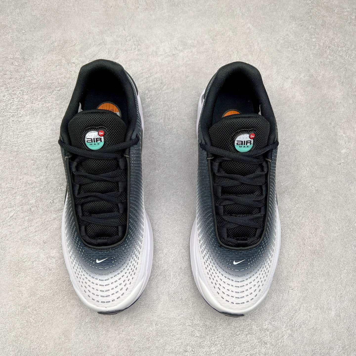 图片[2]-NK Air Max DN系列低帮豆荚型气垫百搭休闲运动慢跑鞋 FB8987-004 Air Max 科技最初于 1986 年推出，是NK的首款气垫鞋款，这个缓震技术彻底改变了人们对运动鞋的认知。在 Nike 的众多缓震科技中也有着自己绝对的地位。除了技术层面的创新，Air Max 还具有深厚的文化内涵。它所代表的青年文化、前卫风格和反叛精神，使其成为了一种时尚和潮流的象征。为了纪念这个具有里程碑意义的技术，Nike 在每年的 3 月 26 日定为「Air Max Day」。近日，Nike 露出了一款全新的鞋型——Air Max DN。这款鞋不仅具有时尚的外观，还融合了许多经典的 Air Max 设计和元素，同时展现了一些新的创意。设计灵感源自经典 Air Max 97 和 Air Max Plus 的元素。鞋面的条纹设计和后跟的标志都在向这些经典鞋款致敬。最大亮点是 Air Max 气垫的造型，它以神似豆荚的造型呈现，分为四个分区圆形开窗，带来极高的辨识度。Air Max DN 采用了纯黑配色覆面，搭配白色虚线和紫色点缀，营造出一种低调而时尚的外观。鞋面采用织物材质打造，提供舒适的穿着体验。全新 Nike Air Max DN 除了图中的配色外，还将有荧光绿、白银、黑银、皇家蓝、酷灰、黑色等六款新配色登场。具体发售信息感兴趣的朋友可以持续关注。尺码：36 36.5 37.5 38 38.5 39 40 40.5 41 42 42.5 43 44 44.5 45-选品中心