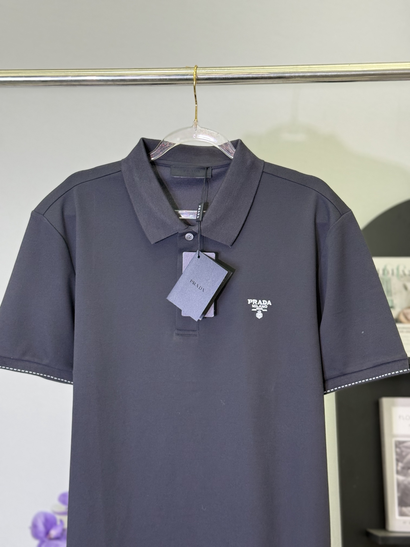 P150💋 Polo Prada con logo en gris oscuro con letras Pon la estética minimalista italiana de Prada en este polo gris os…