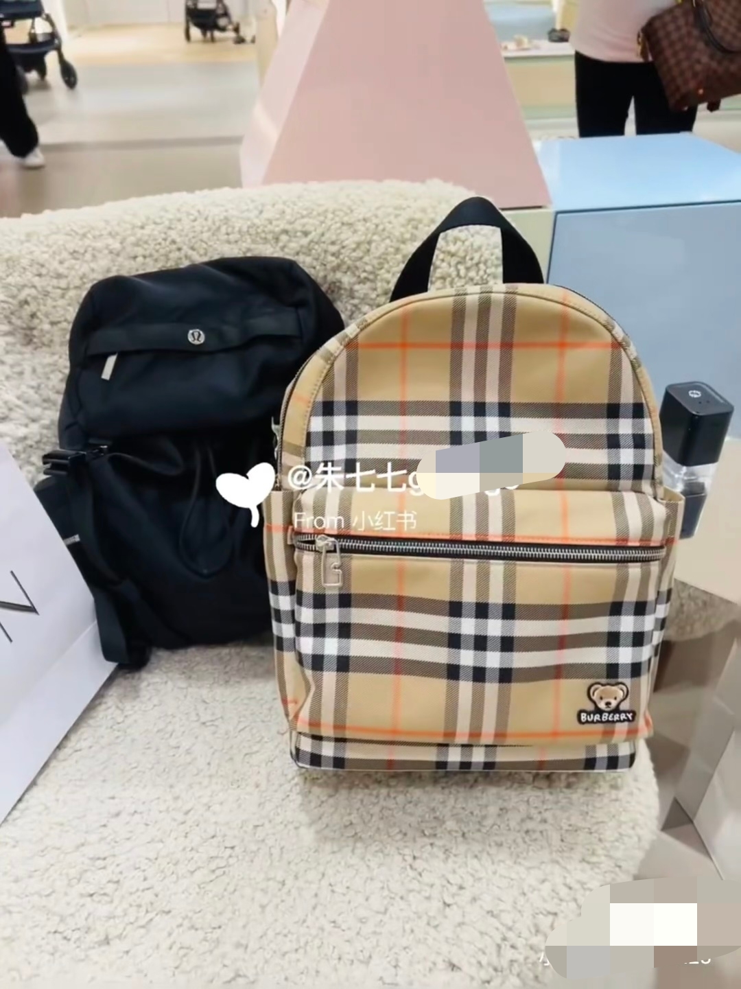 New compact backpack made of nylon fabric. Decorated with worsted Burberry check and solid color lining. Leather base with embroidery and appliqu