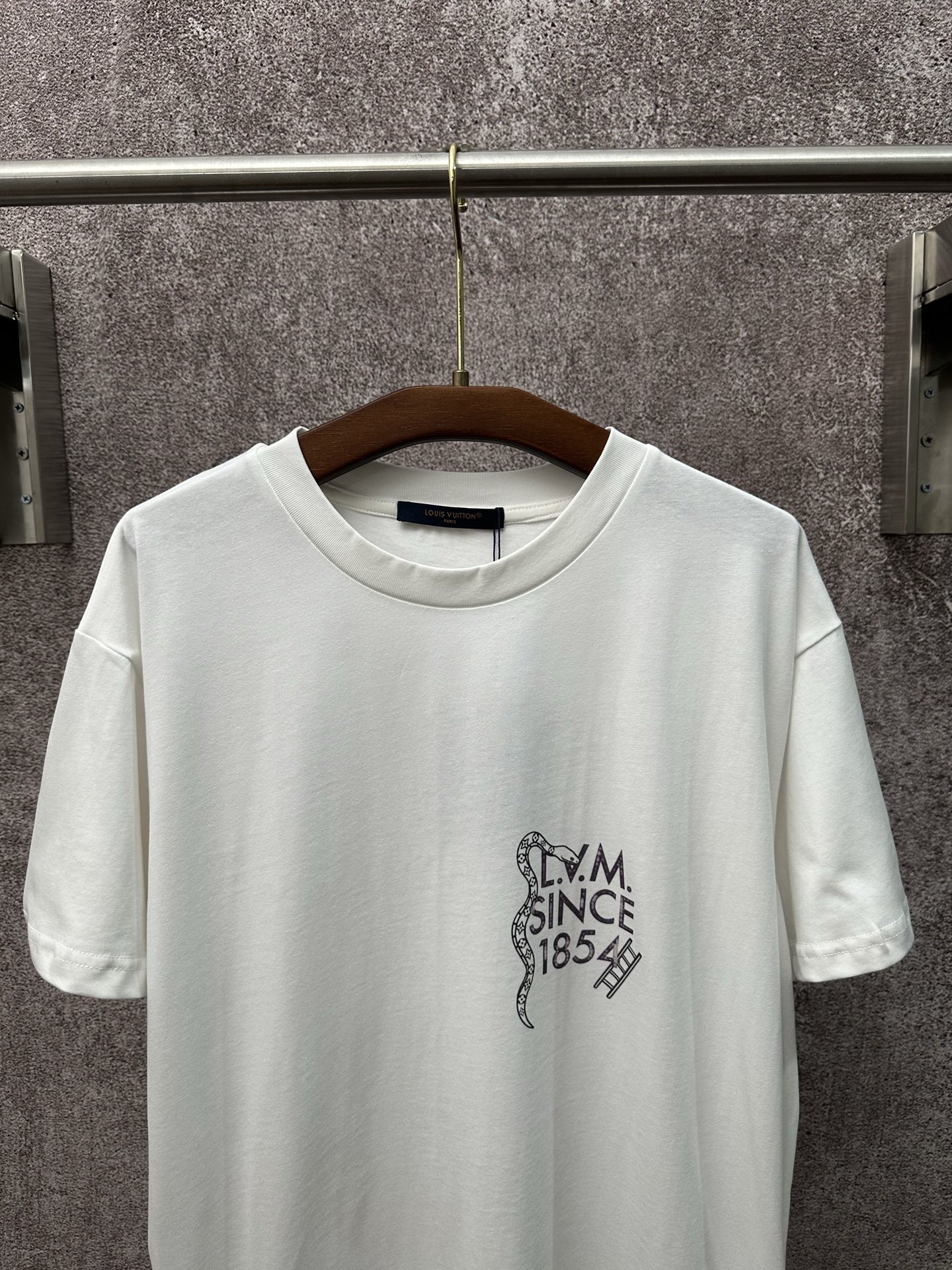 💰p155
【上新】1V26ss圆领印花短袖T恤 
采用高端成衣工艺打造，面料甄选230g重磅双股精梳棉，经酵素洗水工艺处理，让棉料触感柔软且不易起球、变形，同时保留棉质的透气与亲肤特性。后背主题印花采用数码直喷结合丝网印的复合工艺，先以数码直喷还原图案的色彩层次与细腻纹理，再用丝网印勾勒图案轮廓线条，使印花色彩牢固度提升30%，反复洗涤也不褪色、不开裂。领口采用二本针包边工艺，搭配高弹罗纹面料，耐拉扯且久穿不变形，衣身侧缝与肩缝均为埋夹工艺缝制，针脚细密平整，整体版型通过立体剪裁打造宽松落肩效果，兼顾穿着舒适度与版型挺括度。整体走线平直细腻，面料舒适柔软，颜色一致无色差 能与同款搭配营造时尚造型，驾驭各种场合，定制辅料，三标齐全，男女同款！
Size：S M L XL