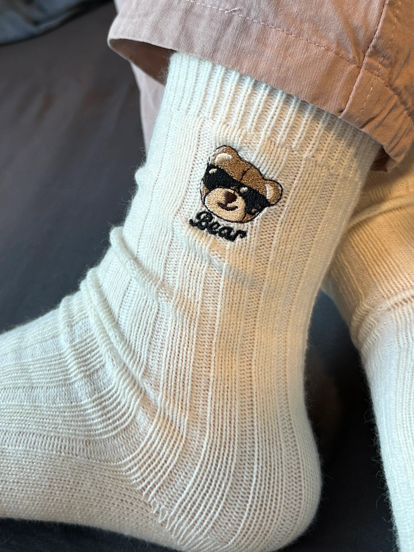 Knit socks featuring detailed bear embroidery and an extended - Comprehensive 4