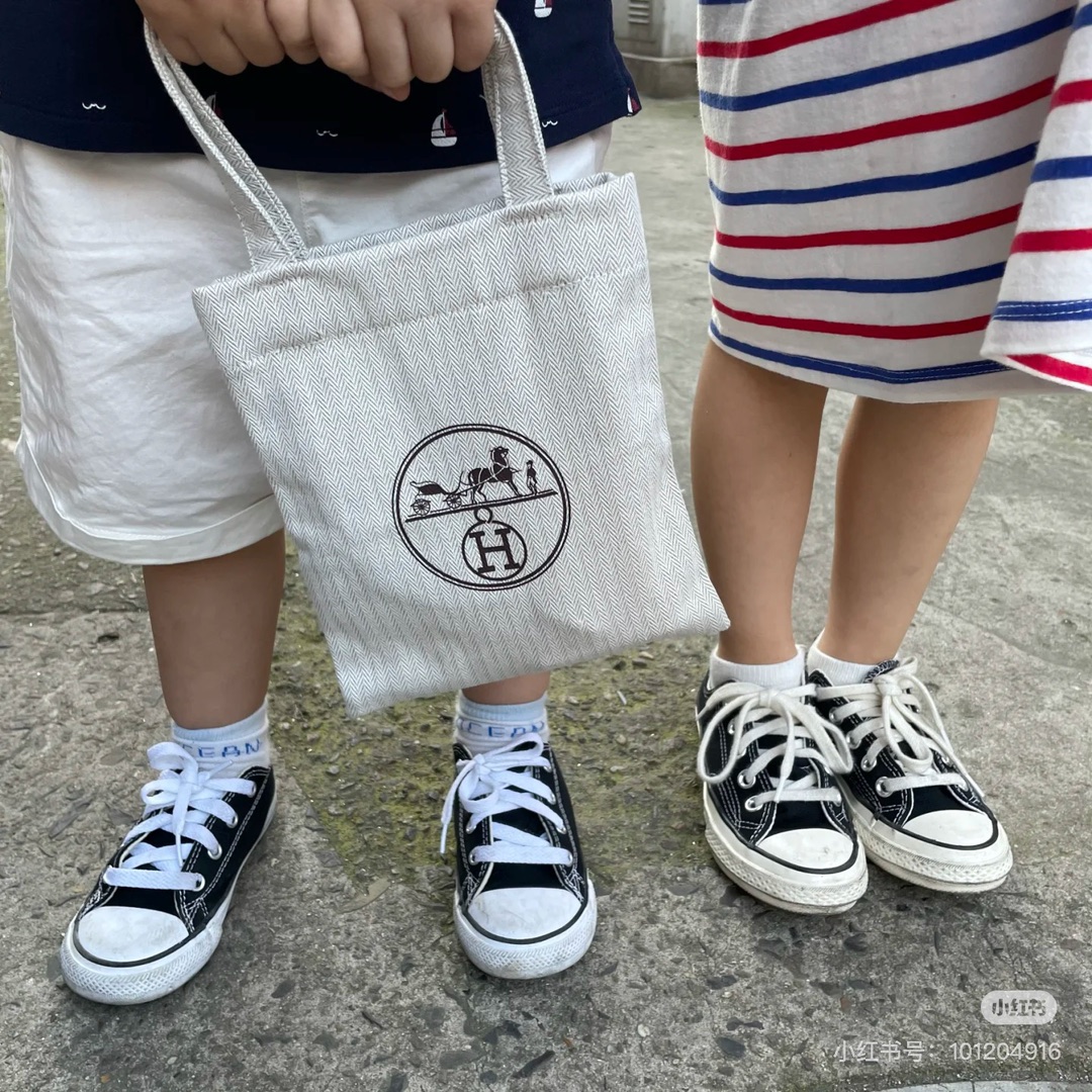 An understated canvas tote characterized by a minimalist silhouette and - Bag 4