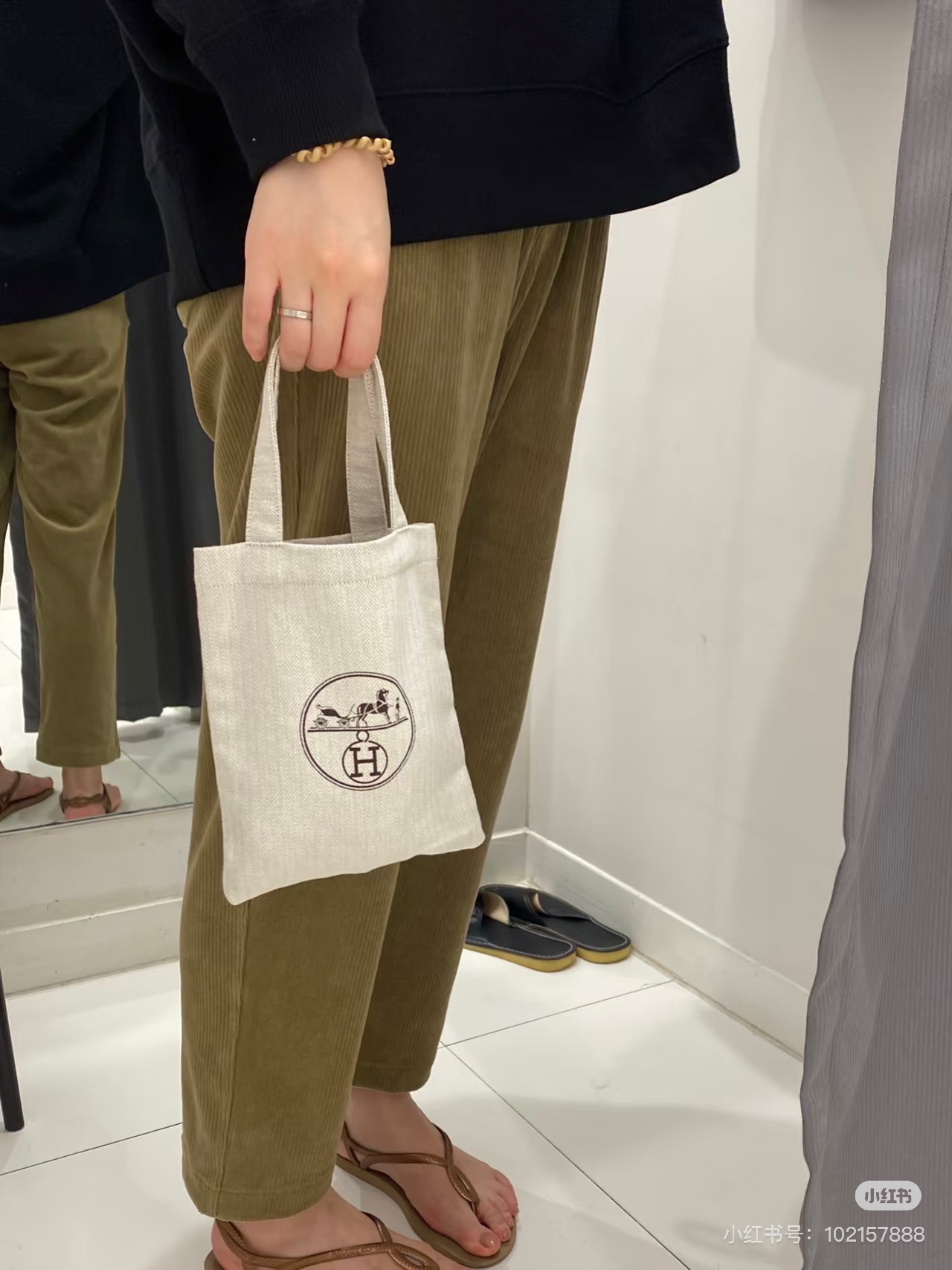 An understated canvas tote characterized by a minimalist silhouette and - Bag
