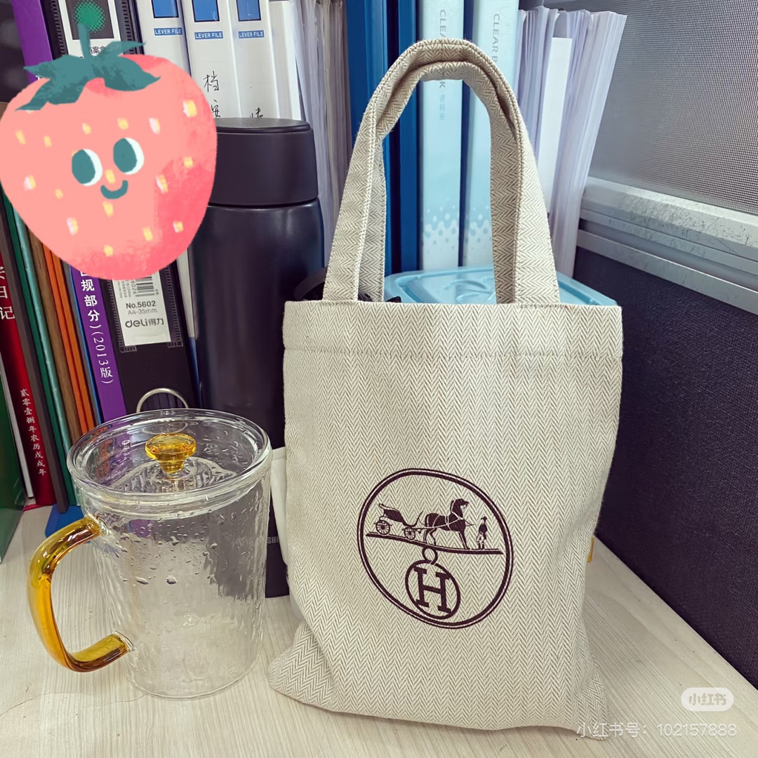 An understated canvas tote characterized by a minimalist silhouette and - Bag 2