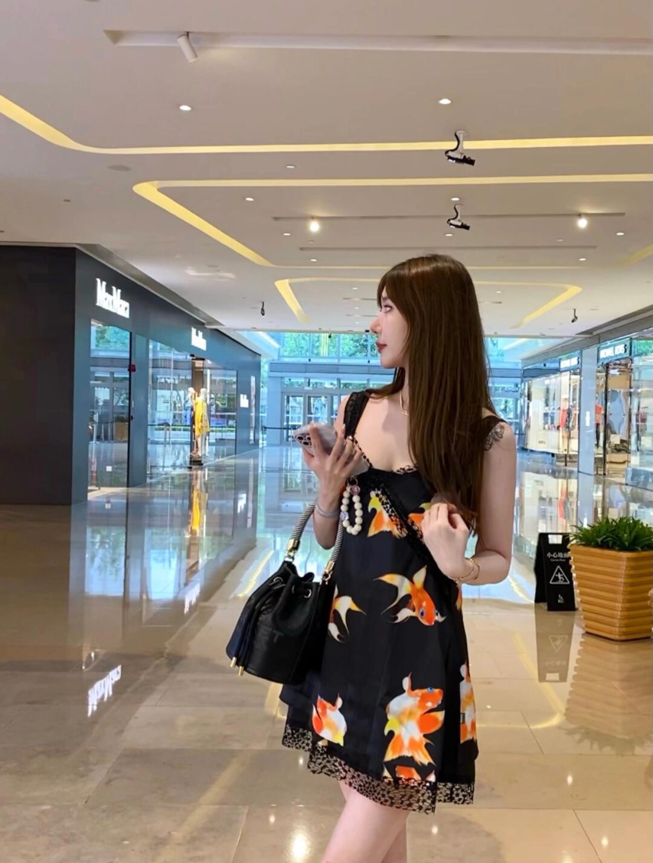 A compact bucket bag designed for top-handle or crossbody wear, offering - Bag 9