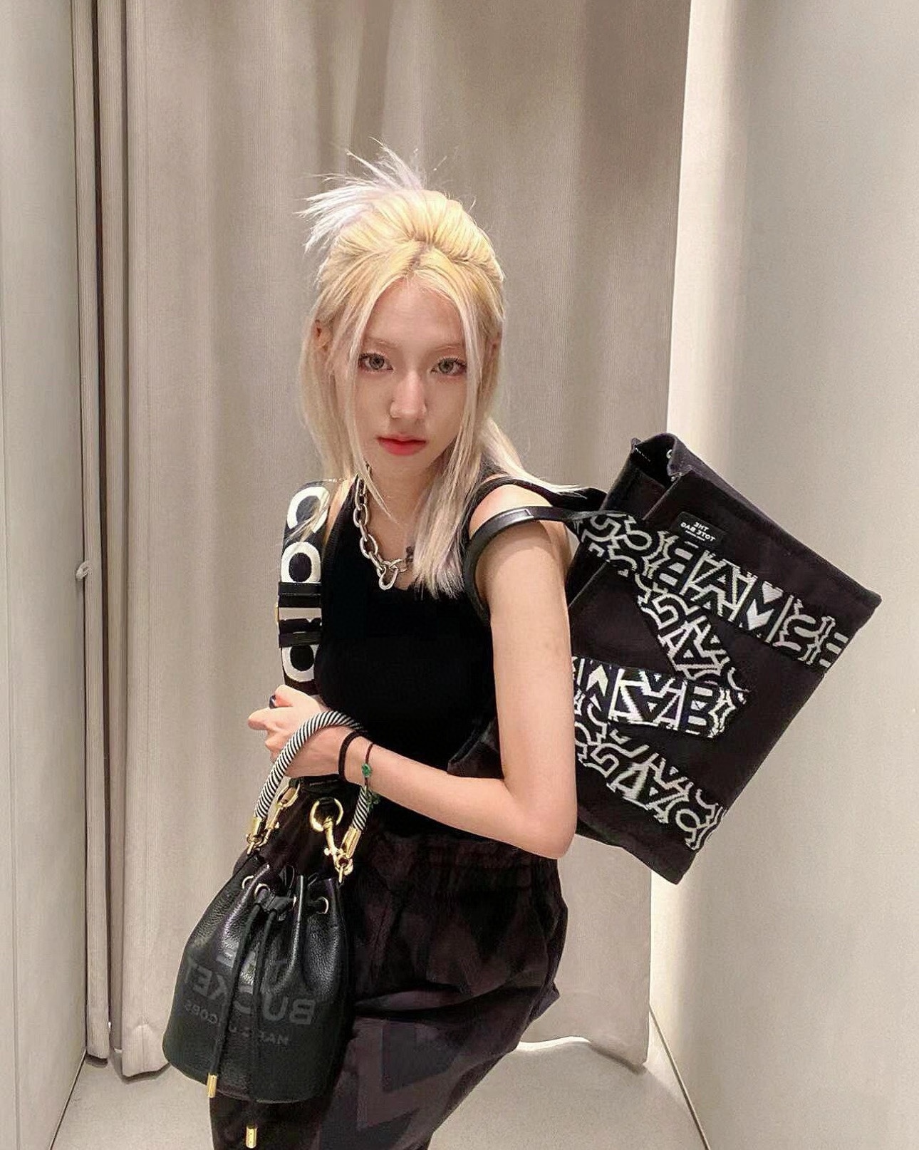 A compact bucket bag designed for top-handle or crossbody wear, offering - Bag 4