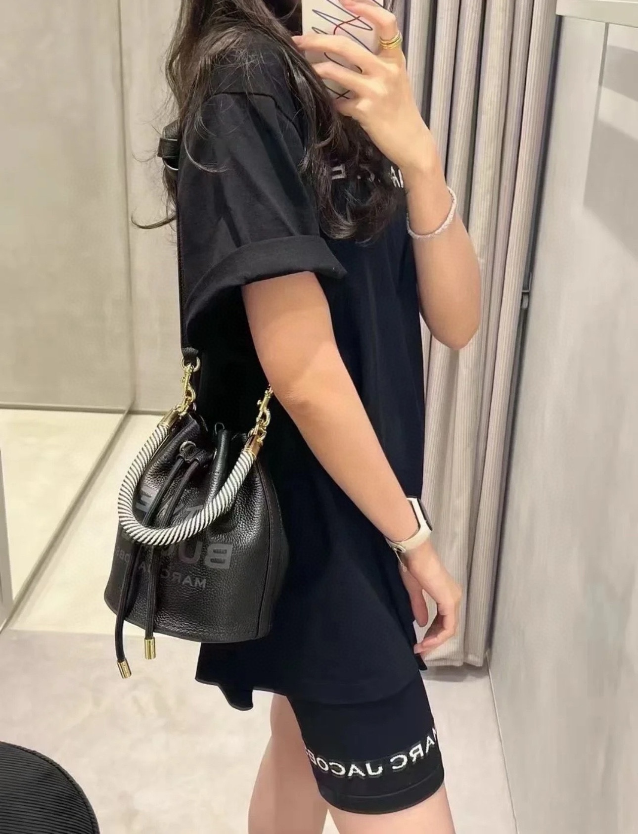 A compact bucket bag designed for top-handle or crossbody wear, offering - Bag 7