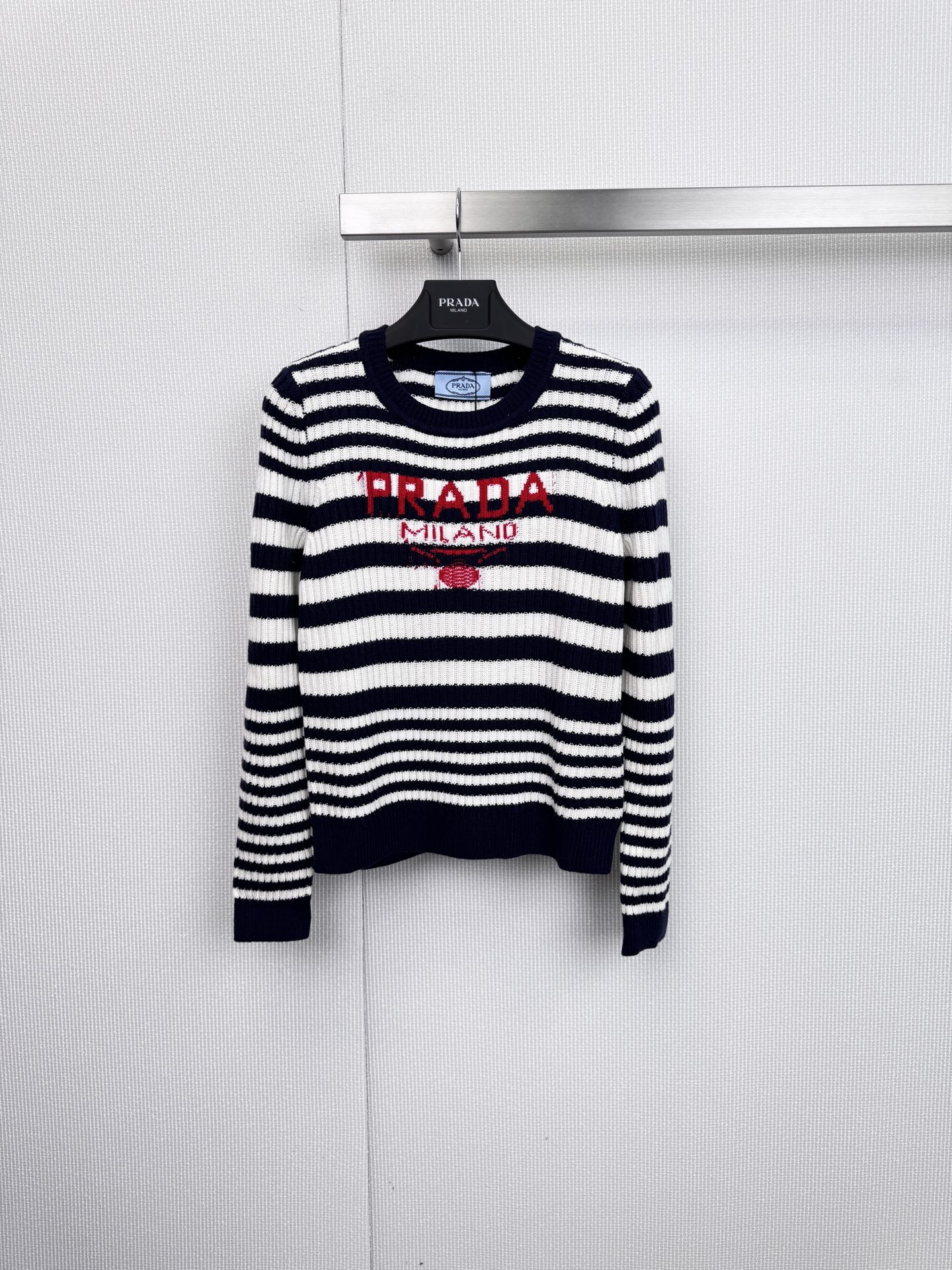 NO:627759,PRADA's classic striped sweater is made of high-quality blended fabrics in Italy. It combines the brand's iconic logo print with a simple and comfortable fit to create a daily essential item with both casual texture and luxurious style. The sweater adopts a classic black and white or gray and brown wide stripe design. The color is calm and highly recognizable, which can easily enhance the sense of layering. The chest is eye-catchingly decorated with 'PRADA' in red or dark blue.  'MILANO' embroidered/printed badge instantly lights up the overall look and highlights the extraordinary taste. The round neck design is matched with rib knitted cuffs and hem to ensure comfort and a neat silhouette. The solid color splicing used in the collar, cuffs, etc. adds to the design ingenuity. The ingredients are 45 wool, 35 acrylic, and 20 nylon. This golden ratio retains the warmth and high-quality quality of wool.  It combines the softness of acrylic and the wear resistance of nylon to achieve the perfect balance of comfort and durability. Whether it is paired with casual trousers to create a simple and comfortable weekend trip look, or layered with a suit jacket to inject a touch of casual elegance into a commuting look, this sweater is an indispensable fashion tool. Size SML, prada, jackets  & coats,sweaters,business suit,gold,alexander wang19860909PRADA经典条纹毛衣,以优质混纺面料于意大利精制而成,将品牌标志性的徽标印花与简约舒适的版型相结合,打造出兼具休闲质感与奢华格调的日常必备单品,毛衣采用经典的黑白或灰棕宽条纹设计,色调沉稳且极具辨识度,轻松提升穿搭层次感,胸前醒目地装饰着红色或深蓝色的“PRADA MILANO”刺绣/印花徽章,瞬间点亮整体造型,彰显不凡品味,圆领设计搭配罗纹针织的袖口与下摆,确保了穿着的舒适性与利落廓形.领口、袖口等处采用的纯色拼接,更添设计巧思,成分为45羊毛、35腈纶、20尼龙,这一黄金配比既保留了羊毛的保暖性与高级质感,又融入了腈纶的柔软与尼龙的耐磨性,实现了舒适度与耐用性的完美平衡,无论是搭配休闲裤装打造简约舒适的周末出行look,还是与西装外套层叠穿搭,为通勤造型注入一丝随性的优雅,这款毛衣都是不可或缺的时尚利器.码数SML,,prada,jackets & coats,sweaters,business suit,gold,alexander wang,Women's clothing