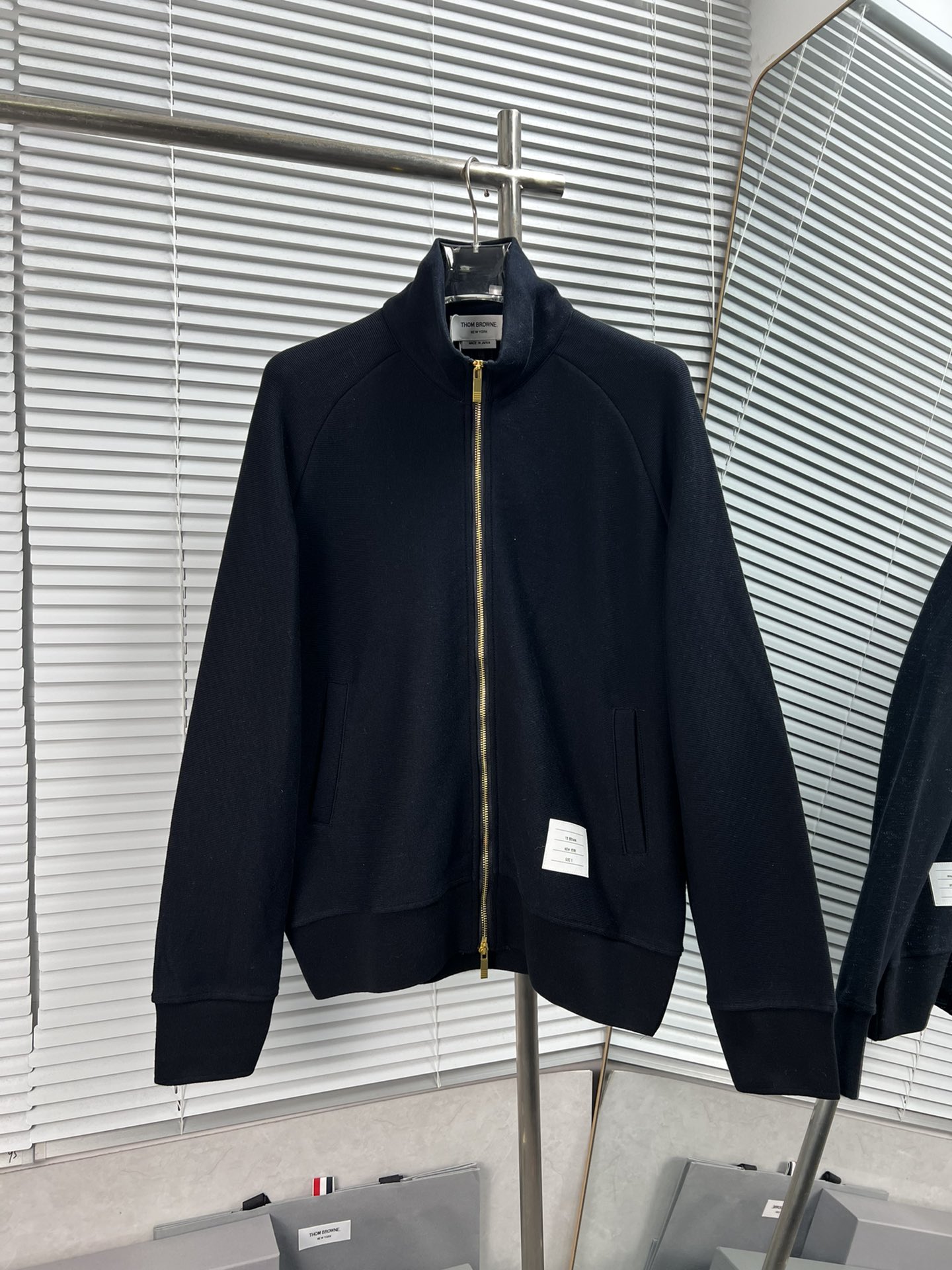THOM BROWNE Nueva chaqueta con cuello alto y rayas rojas, blancas y azules en la espalda. Tejido de felpa ori…