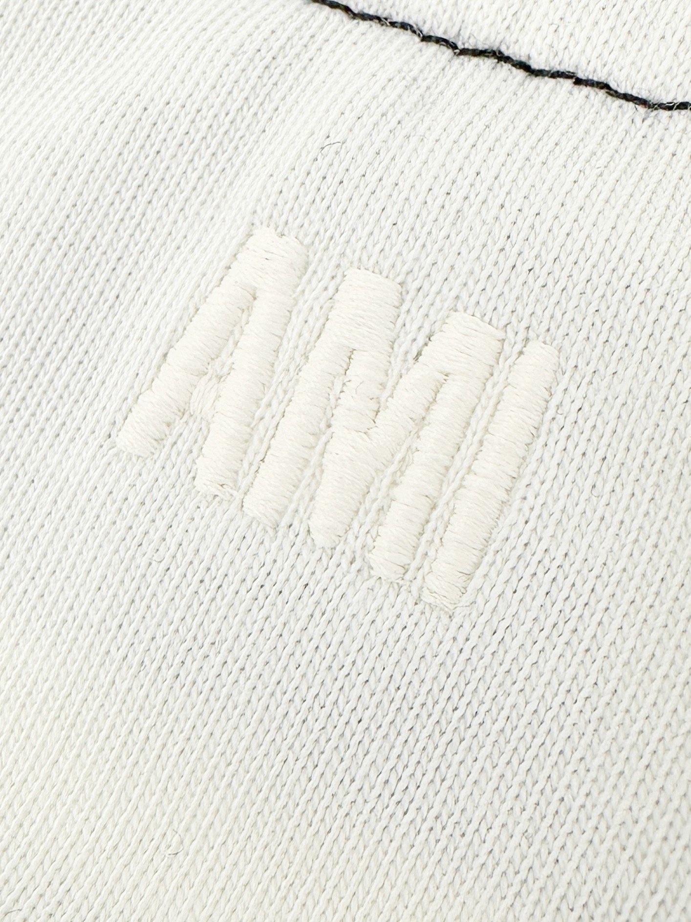 Ami Paris 定制精梳柔密棉 细腻柔软 舒适贴肤 奶杏白底色温润治愈 柔光敛藏温柔 黑插肩袖撞色拼接 利落率性 学院感 胸前钩织爱心徽标悄然绽放 细腻肌理交织奢华触感 Ami字母刺绣隐缀后领 精工针脚 藏而不露的高级 将法式浪漫与 格调 凝于方寸之间