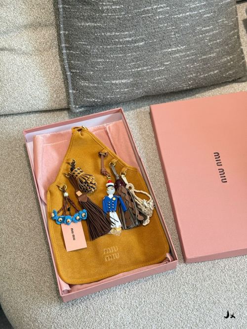 Miu Miu Suede Bag with Robot and Tassel Charms - Playful & Artistic 1 Miu Miu Suede Bag with Robot and Tassel Charms - Playful & Artistic