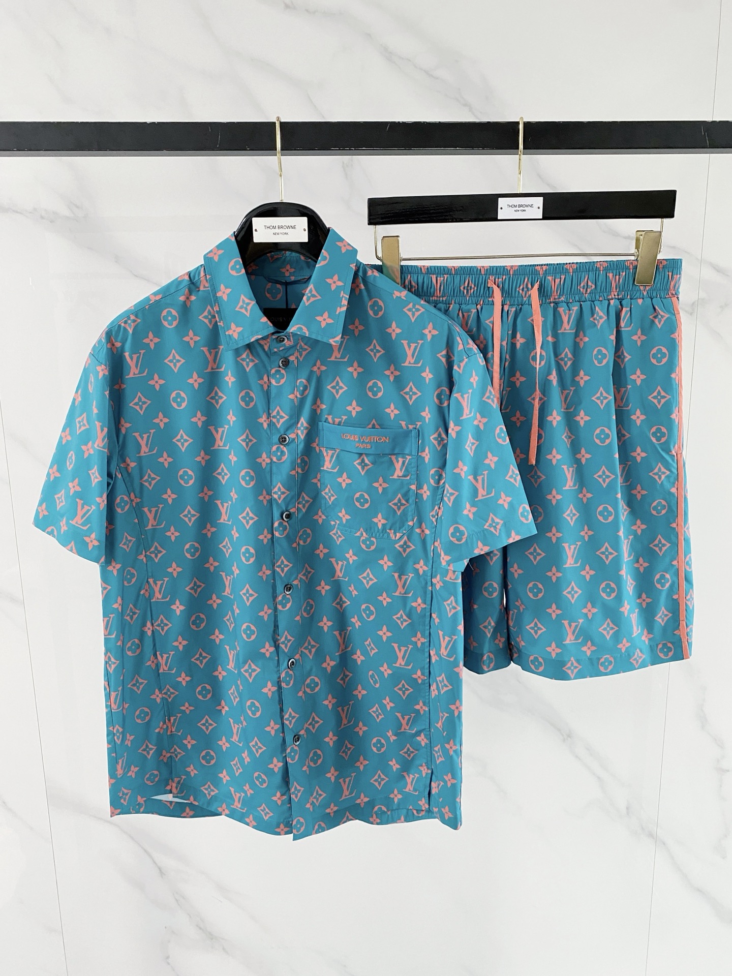 NO:848811,/set LV 2026 spring and summer presbyopia suit, lazy people can just close their eyes and buy it!  The fabric has an extremely light satin texture, drapes silky, and has a cool feeling. It is refreshing and not sweaty when worn in summer. The classic presbyopia is printed with the Monogram logo, making it highly recognizable, and the upper body has a noble buff. The details are full of brand logos on the chest pockets of the shirt, and the contrast webbing on the side of the shorts is low-key and exquisite. Three colors are available: black and gray for calmness, white and gray for refreshing, and blue and pink for eye-catching, suitable for different styles.  The good news for lazy people is that the shirt + shorts are a complete set. You don’t have to worry about putting them together when you go out. You can wear them on vacation or every day!  Size 48-56,,louis vuitton,shorts,shirts,19860909/套 LV 2026春夏老花套装,懒人直接闭眼入！ 面料绝了轻薄缎面质感,垂坠丝滑,自带凉感,夏天穿清爽不闷汗 经典老花加持满印Monogram标识,辨识度拉满,上身自带贵气buff 细节拉满衬衫胸口口袋品牌标识,短裤侧边撞色织带,低调又精致 三色可选黑灰沉稳、白灰清爽、蓝粉亮眼,适配不同风格 懒人福音衬衫+短裤成套搭配,出门不用费心组合,度假/日常都能穿！ 码数48-56,,louis vuitton,shorts,shirts,,Men's clothing
