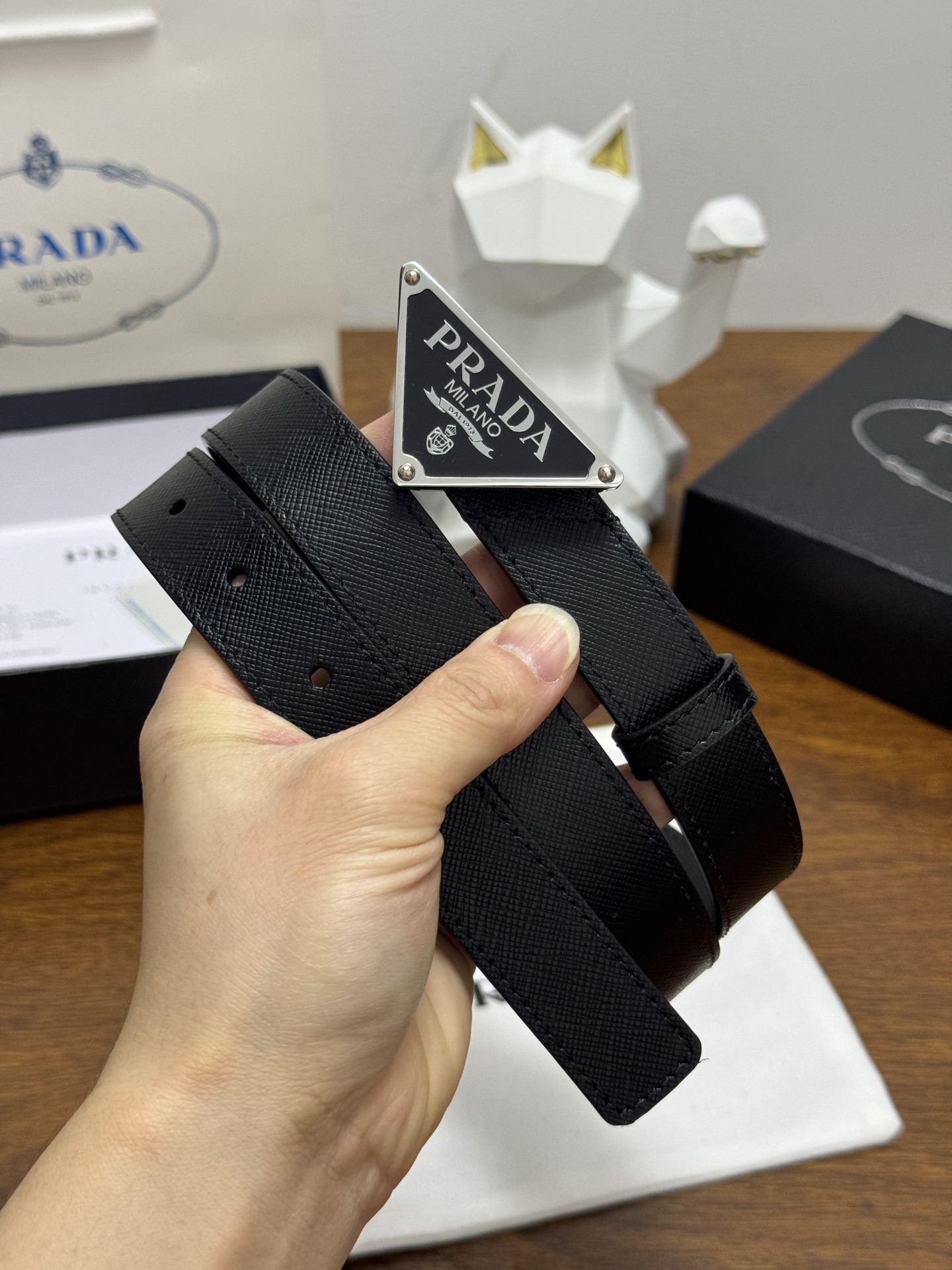 PRADA 2.5cm 颜色：黑色十字纹皮革腰带风格简约之作醒目装饰涂珐琅三角形金属徽标柔软自然，赋予设