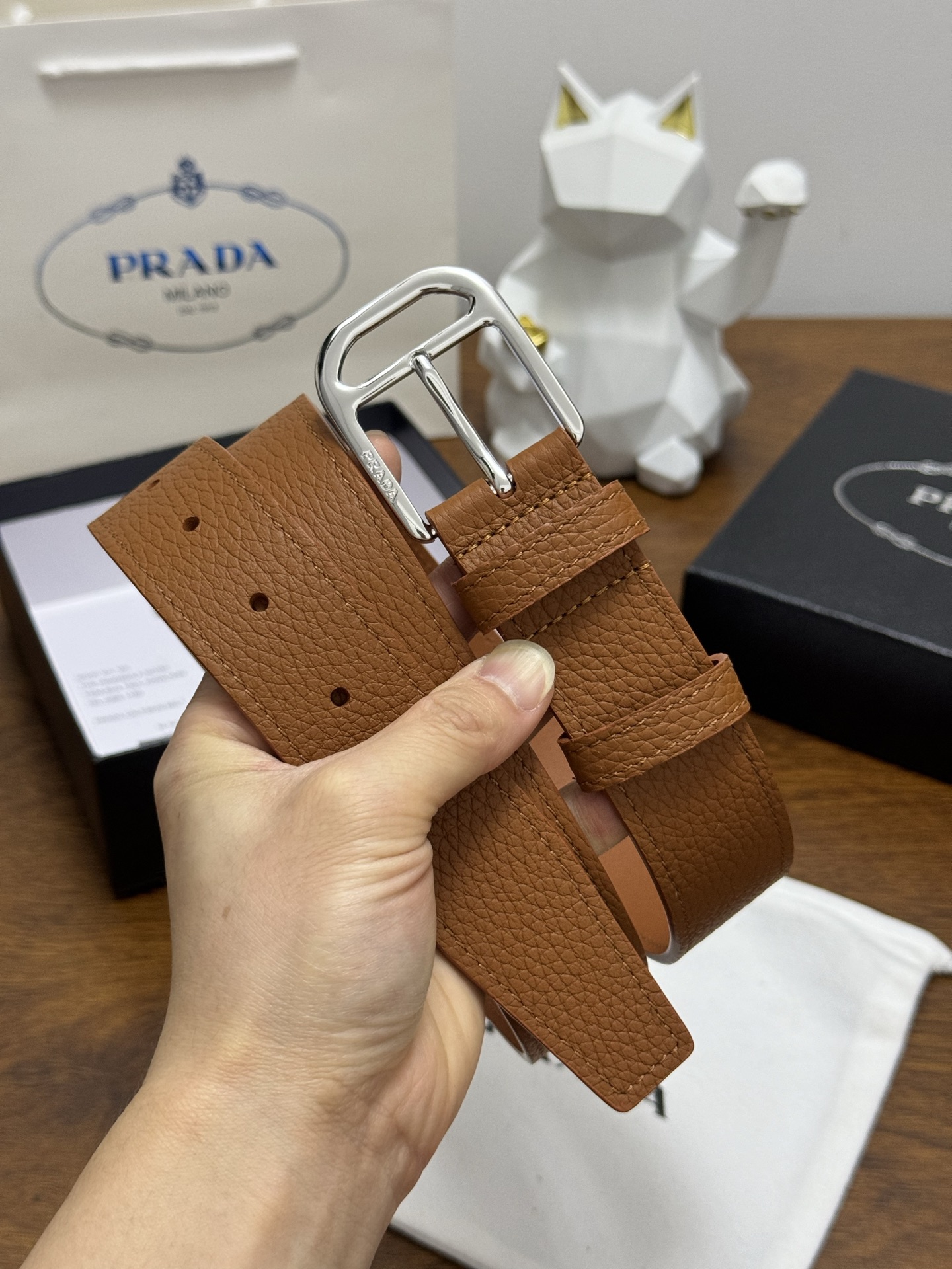 PRADA 3.5cm 颜色：棕色荔枝纹皮革腰带风格简约之作醒目装饰涂珐琅三角形金属徽标柔软自然，赋予设