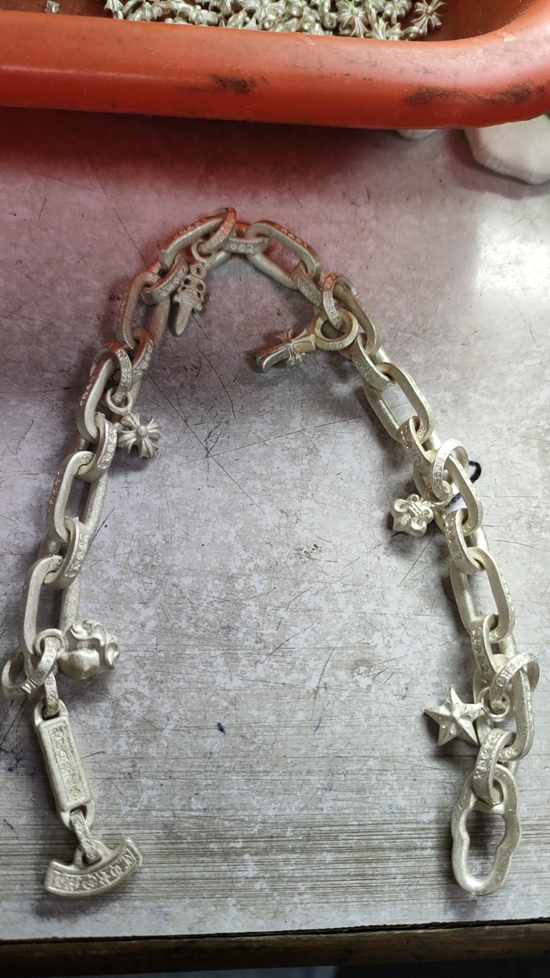 Production process, bracelet and bangle