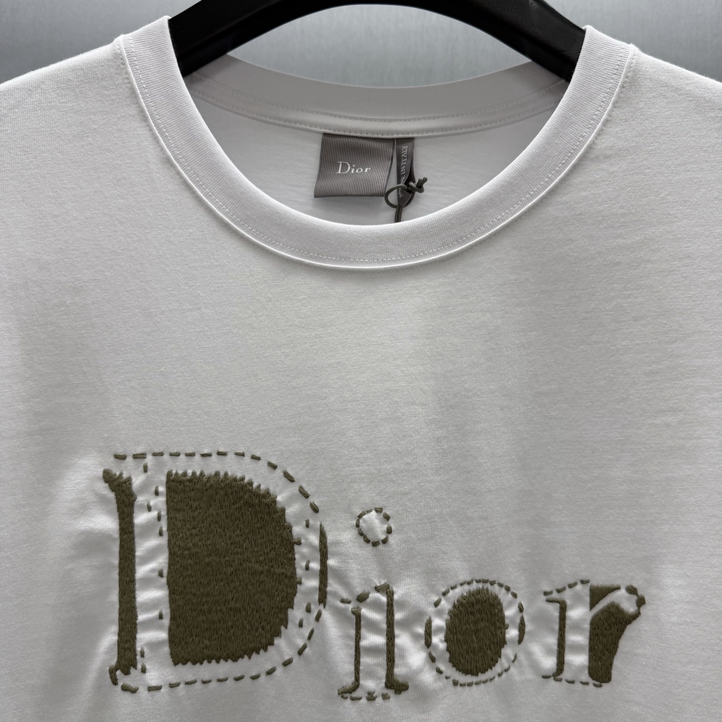 Dior 这款T恤是二零二六夏季男装系列新品 是展现 Dior精湛工艺的典范之作 采用黑色棉质平纹针织面料精心制作