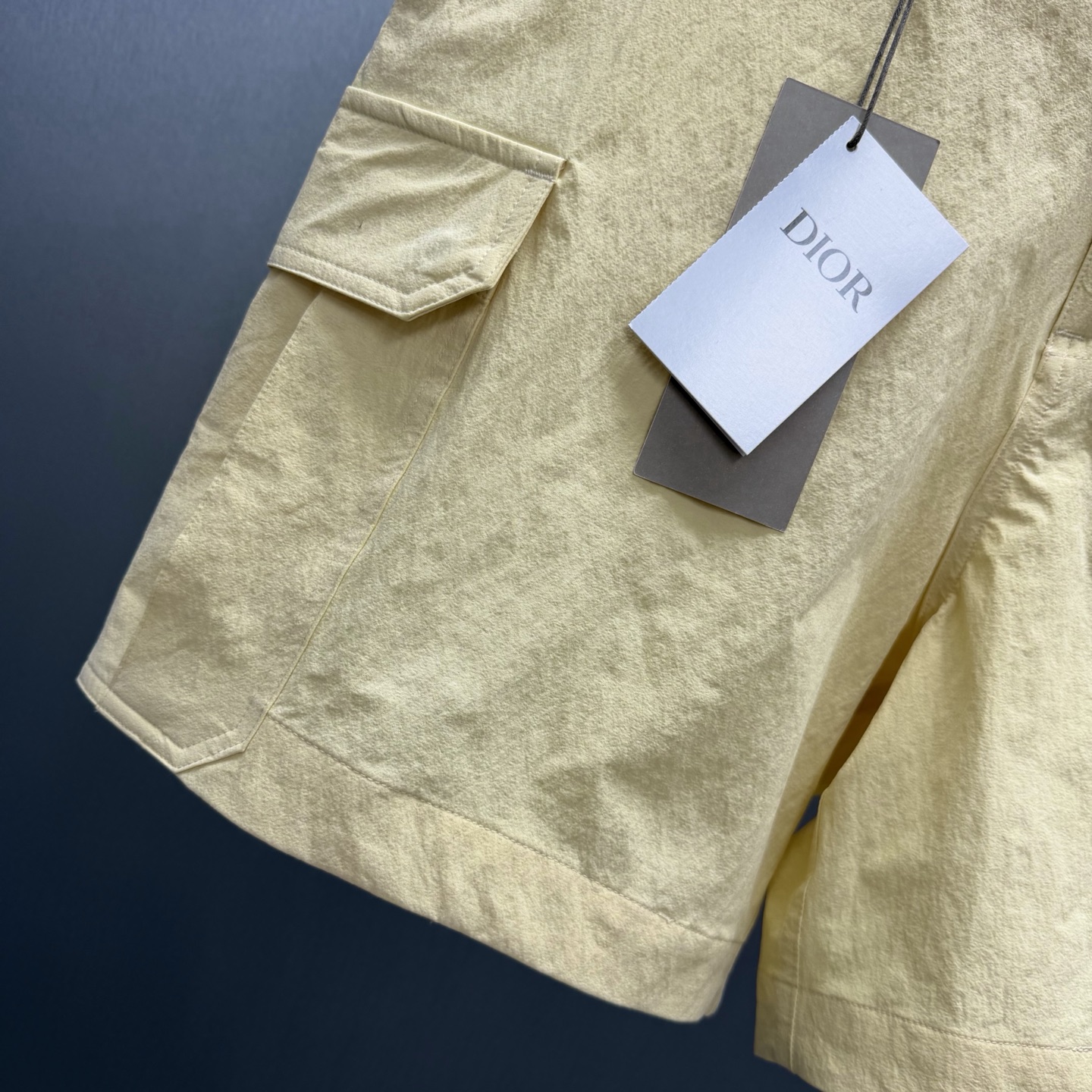 Dior 这款工装短裤是二零二六夏季男装系列新品 演绎 衣橱主打单品 采用海军蓝色科技面料精心制作