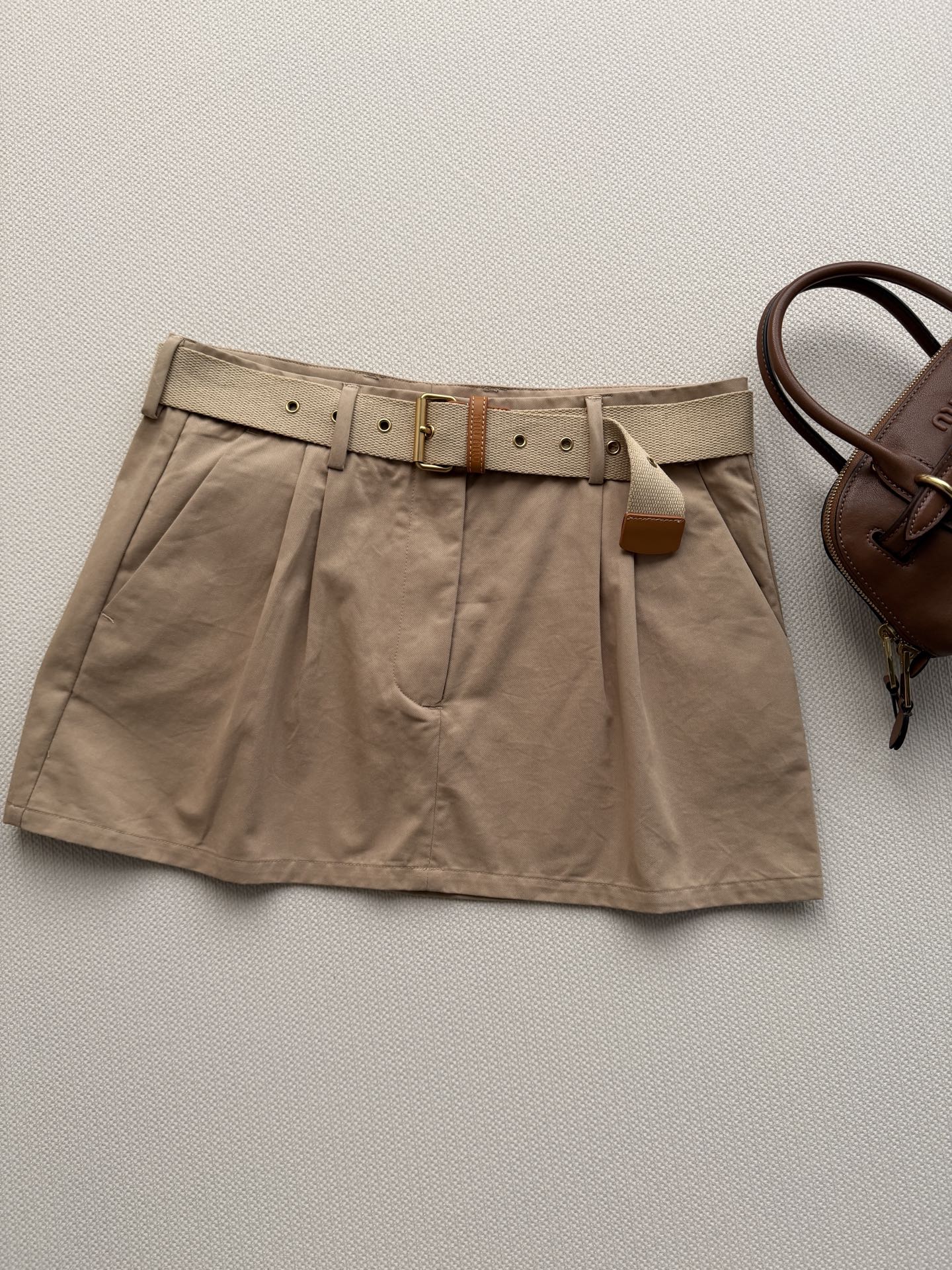 Miumi* 🆕26Ss早春新款 卡其色迷你半裙丨⚠独家yb开发！顶级高版出品！设计重塑学院风。搭配腰带