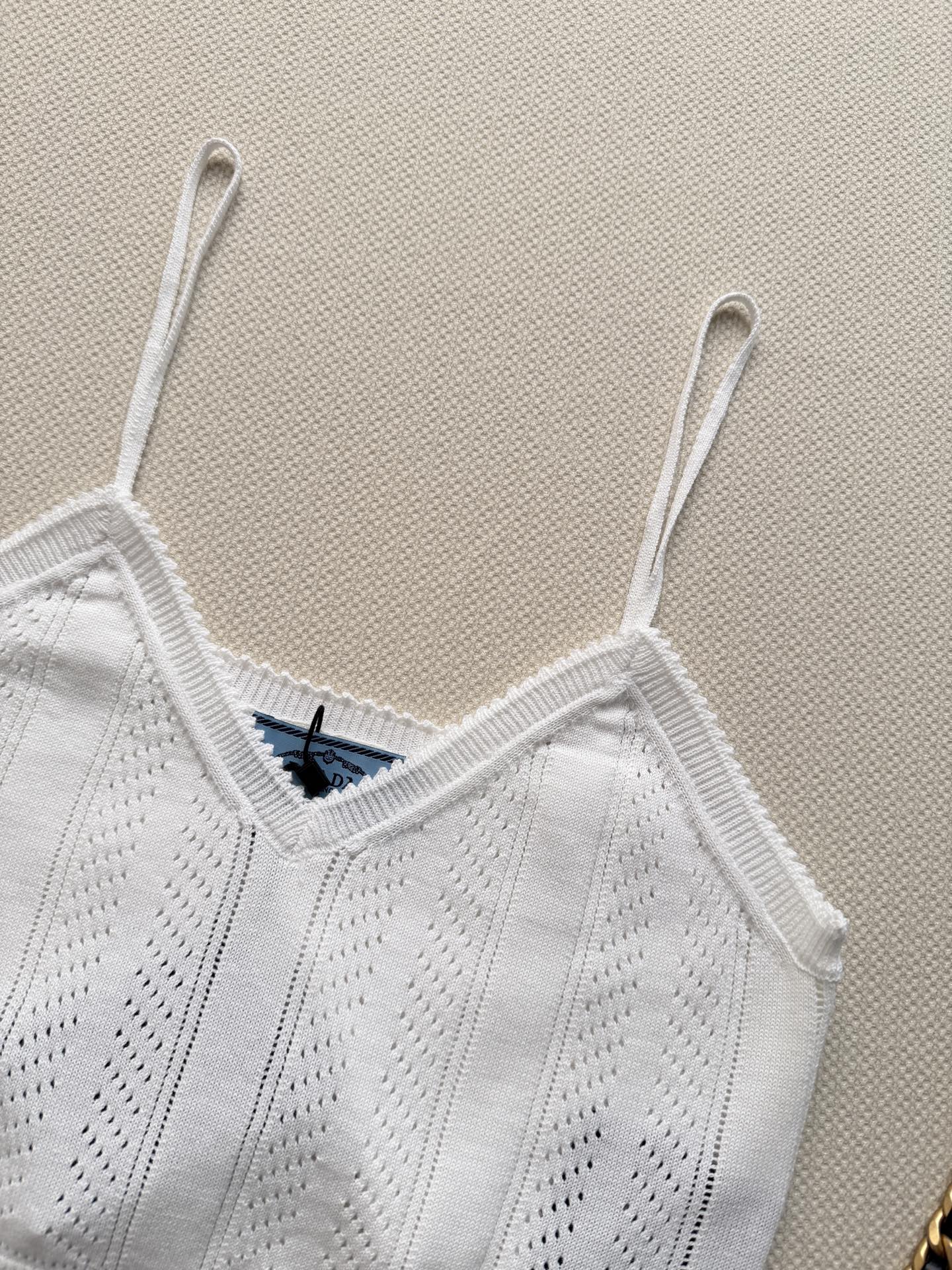 Prada🆕26s夏季新款白色针织吊带，采用轻薄透气针织面料，镂空花纹设计超有层次感✨。简约优雅又不失细