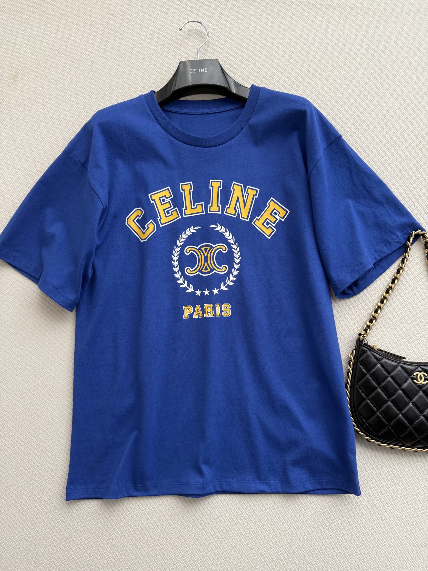 Celin*🆕短袖T恤以经典凯旋门徽标与“CELINE*PARIS”字母印花为视觉核心，采用宽松廓形剪裁，搭配牛仔短裤与