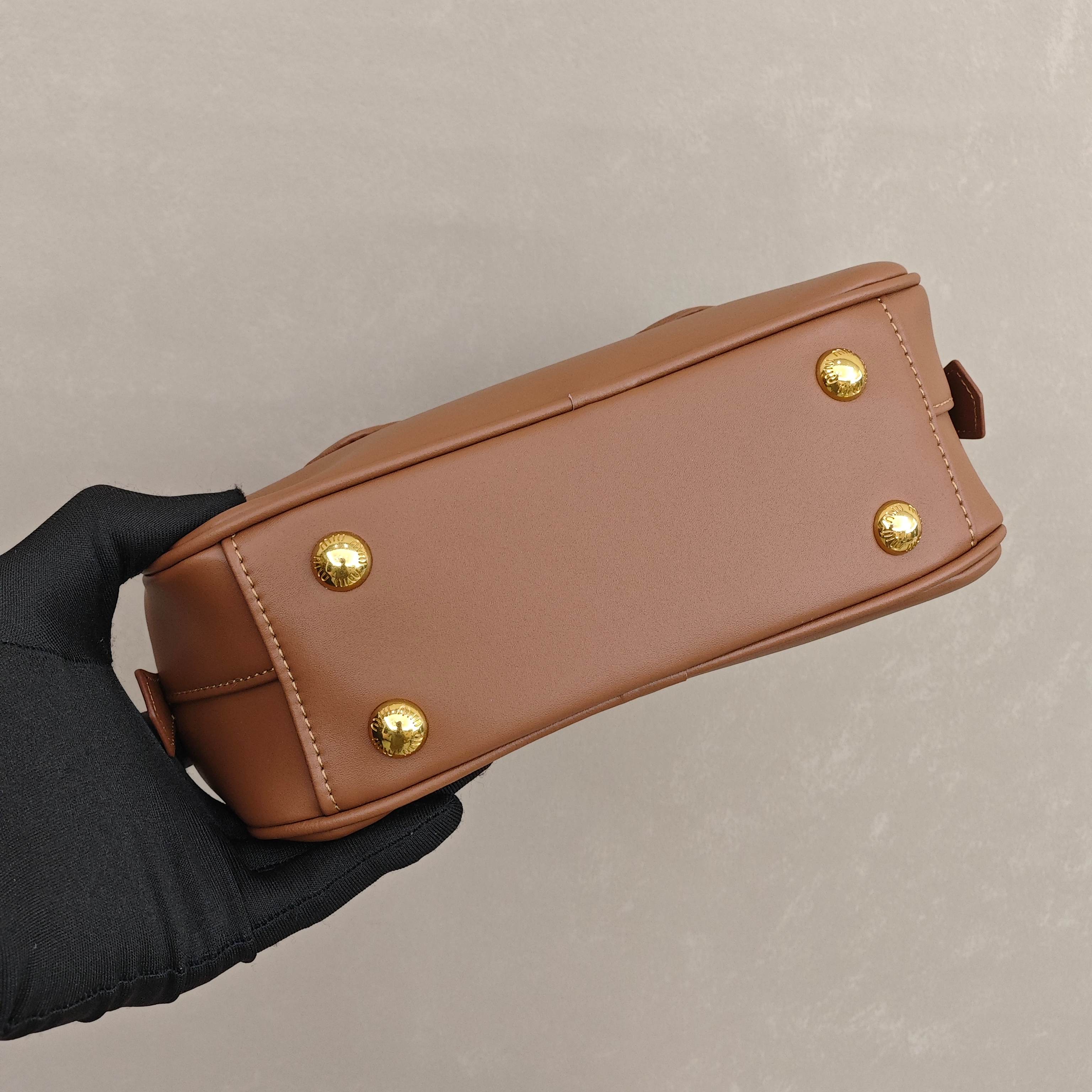 缪缪保龄球包 尺寸：22×10.5×7.5cm简介：细腻光滑的皮革材质，带着恰到好处的哑光质感，焦糖色调