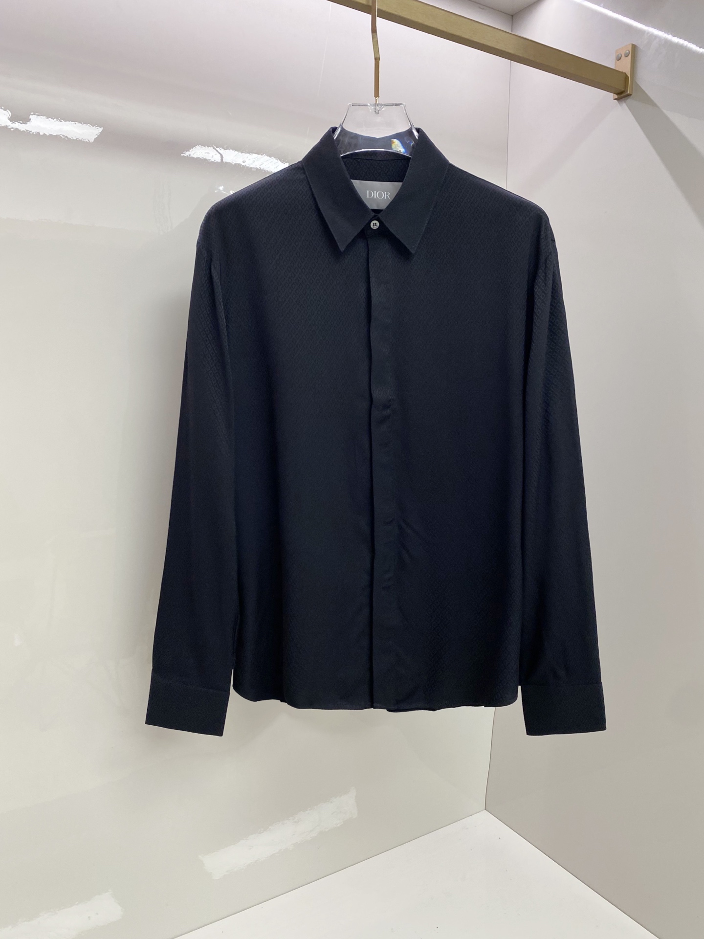 NO:835114,Dior Dior  2026ss spring and summer dark pattern jacquard black shirt, using the brand's iconic rhombus jacquard and minimalist tailoring to interpret the dark high-end relaxed aesthetics. It is made of high-draping satin fabric, with a matte soft texture, feels silky and skin-friendly, and the upper body is draped and stylish; the body is made of  The neat straight silhouette, all-over rhombus dark jacquard low-key injects brand recognition, and the hidden placket design makes it more refined and neat. Whether worn alone to create a cool commuting style, or layered with a suit to create a business elite look, it can easily create an effortless high-quality outfit.  Size 48-56,,dior,dior,shirts,business suit,19860909Dior 迪奥 2026ss春夏暗纹提花黑衬衫,以品牌标志性菱形提花与极简剪裁诠释暗黑系高阶松弛美学.甄选高垂坠缎面面料打造,自带哑光柔光质感,触感丝滑亲肤,上身垂坠有型；衣身采用利落直筒版型,满幅菱形暗纹提花低调注入品牌辨识度,门襟隐藏式设计更显精致利落.无论是单穿打造酷感通勤风,还是叠穿西装演绎商务精英感,都能轻松塑造不费力的高级质感穿搭. 码数48-56,,dior,dior,shirts,business suit,,Men's clothing