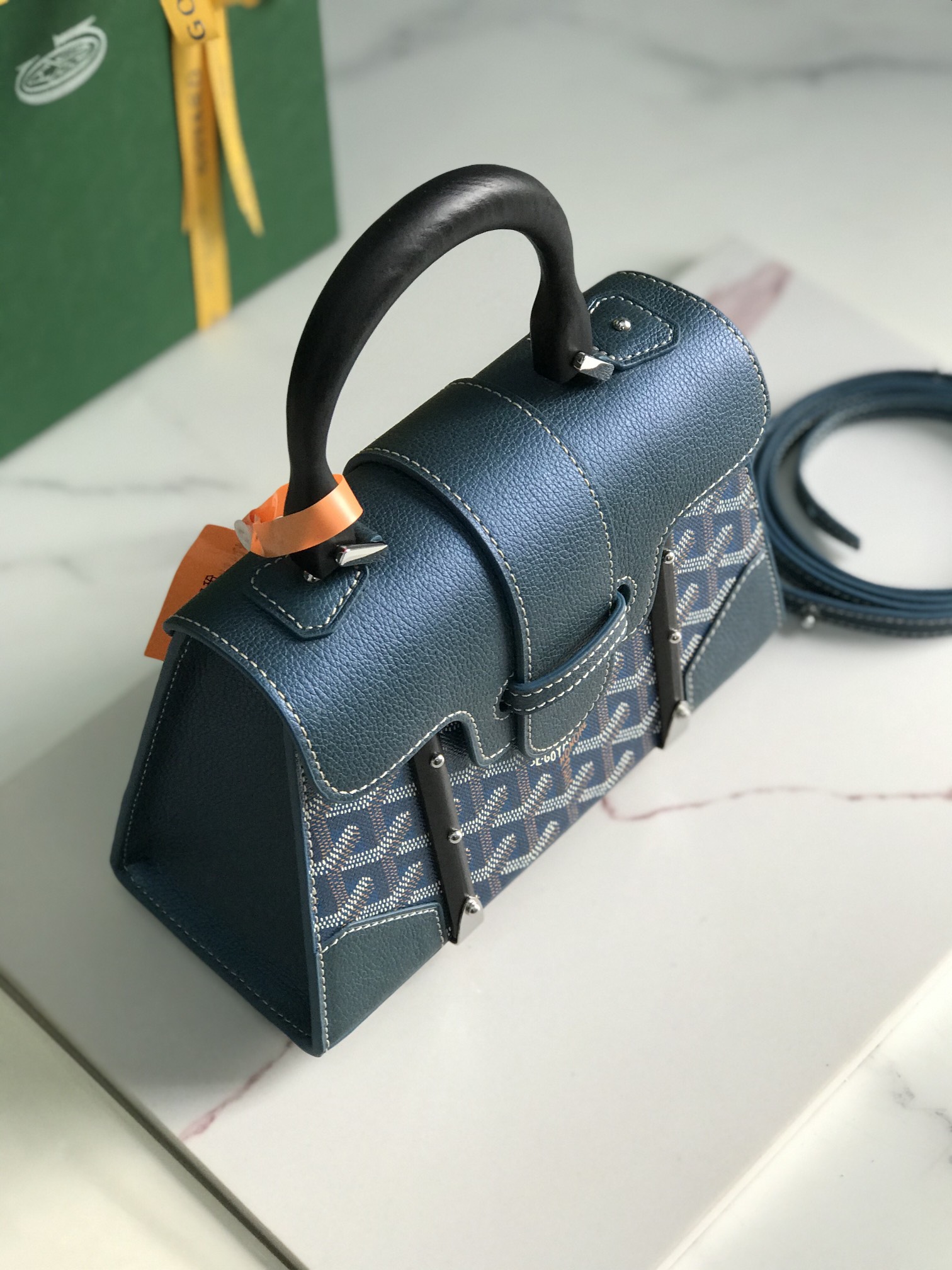 p750。💗配原版盒🎁
珠光蓝上新！
Goyard Saïgon包于二十世纪三十年代问世，继推出柔软版Saïgon迷你包后，Goyard推陈出新，坚持对创意的不断追求与突破，塑造了全新结构化的Saïgon迷你包。它与初版Saïgon包的外型一样，拥有简约的几何线条与制箱工艺的细节，以小巧精致的外观唤起Goyard独一无二的优雅魅力及旅行精神。风格经典又符合当代人偏爱使用“小包”的潮流趋势，是匠心之作。可拆卸的皮革肩带能巧妙地转换成三种背法——手提、斜跨和肩背
尺寸size：21*14*8.5cm 
🔎020192