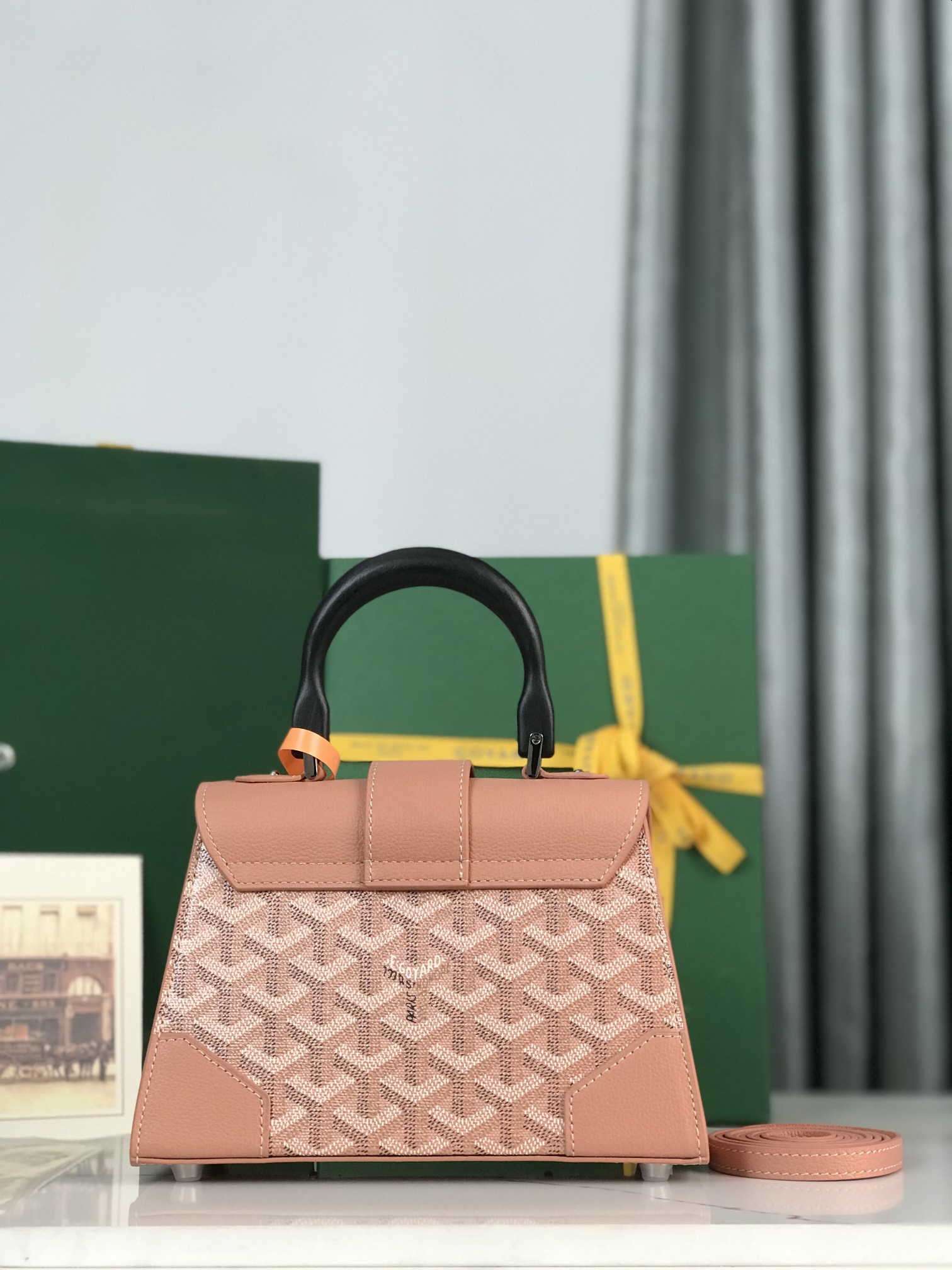 p750。💗配原版盒🎁
珠光粉上新！
Goyard Saïgon包于二十世纪三十年代问世，继推出柔软版Saïgon迷你包后，Goyard推陈出新，坚持对创意的不断追求与突破，塑造了全新结构化的Saïgon迷你包。它与初版Saïgon包的外型一样，拥有简约的几何线条与制箱工艺的细节，以小巧精致的外观唤起Goyard独一无二的优雅魅力及旅行精神。风格经典又符合当代人偏爱使用“小包”的潮流趋势，是匠心之作。可拆卸的皮革肩带能巧妙地转换成三种背法——手提、斜跨和肩背
尺寸size：21*14*8.5cm
🔎020192