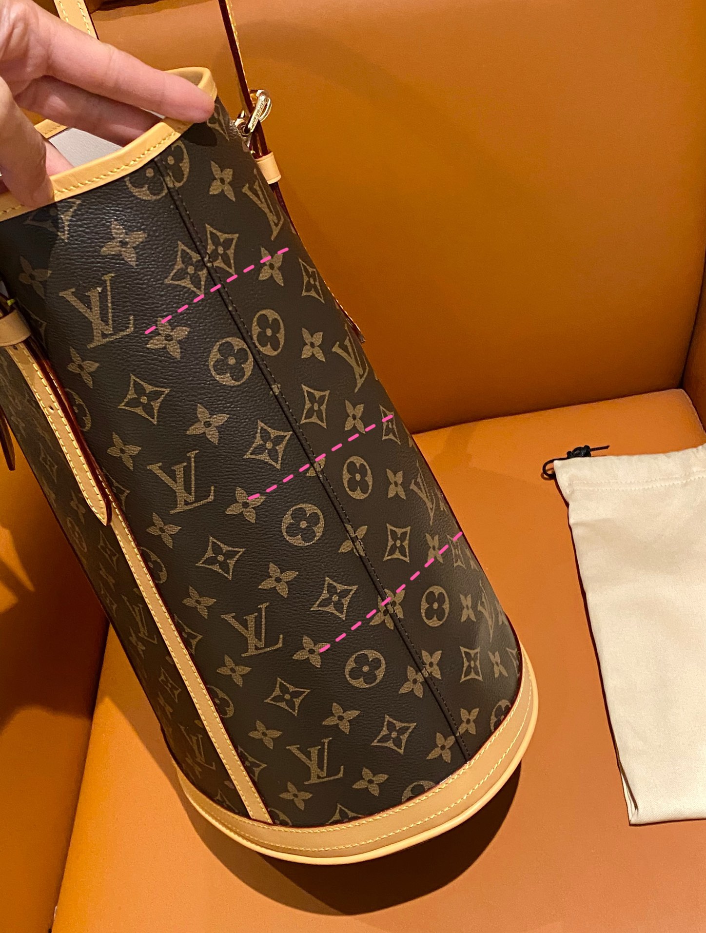 Structured monogram bucket bag featuring precision pattern alignment and - Comprehensive 3