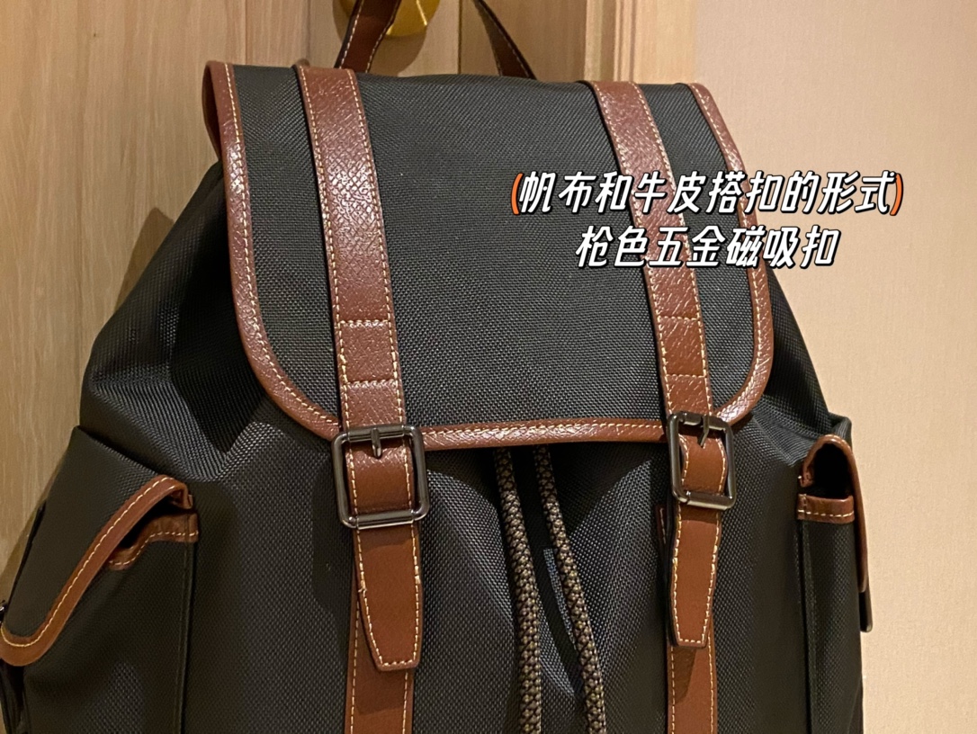 Crafted in canvas with a calfskin leather tab closure, this piece featur - Comprehensive