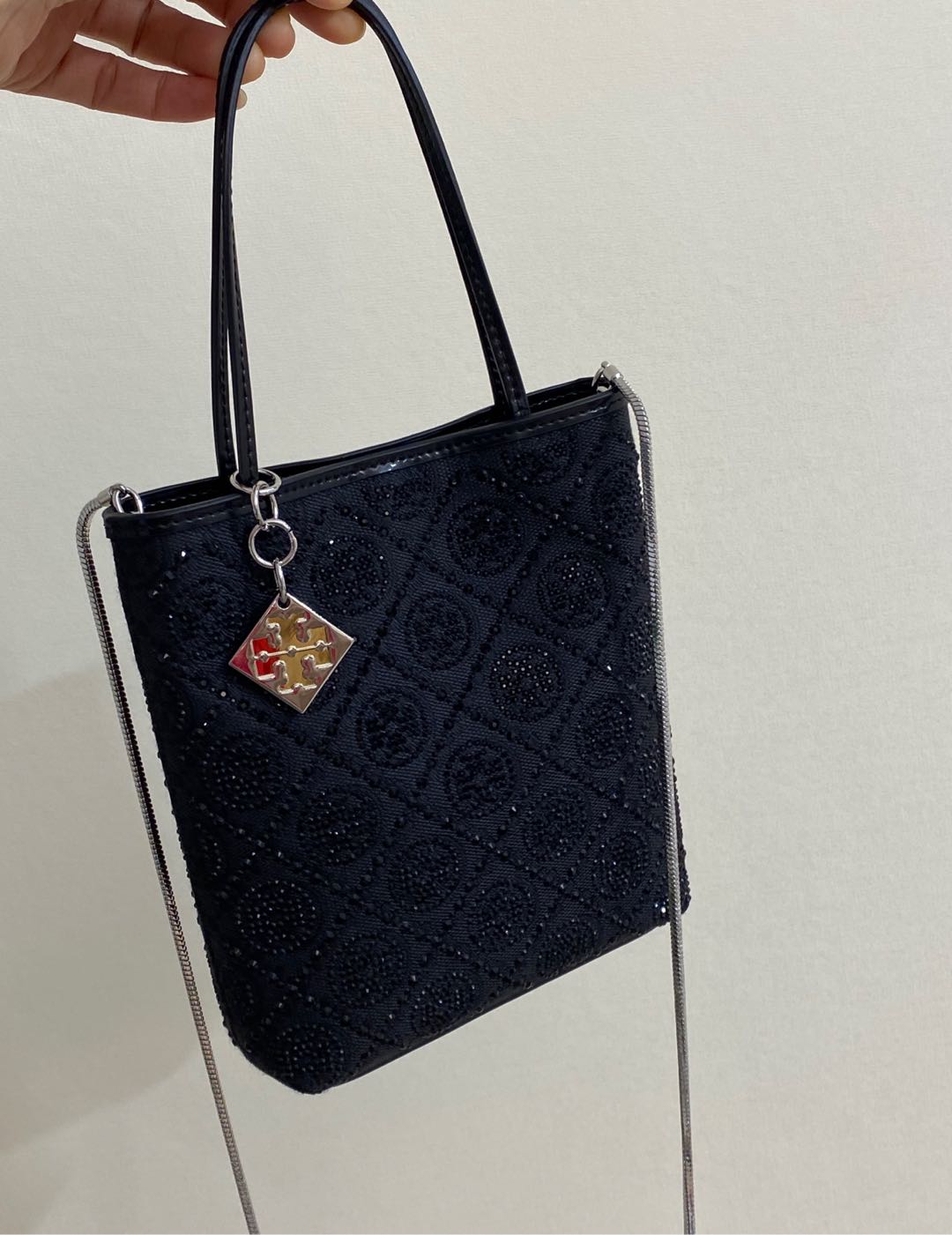 Compact mini tote silhouette designed to accommodate daily essentials - Comprehensive