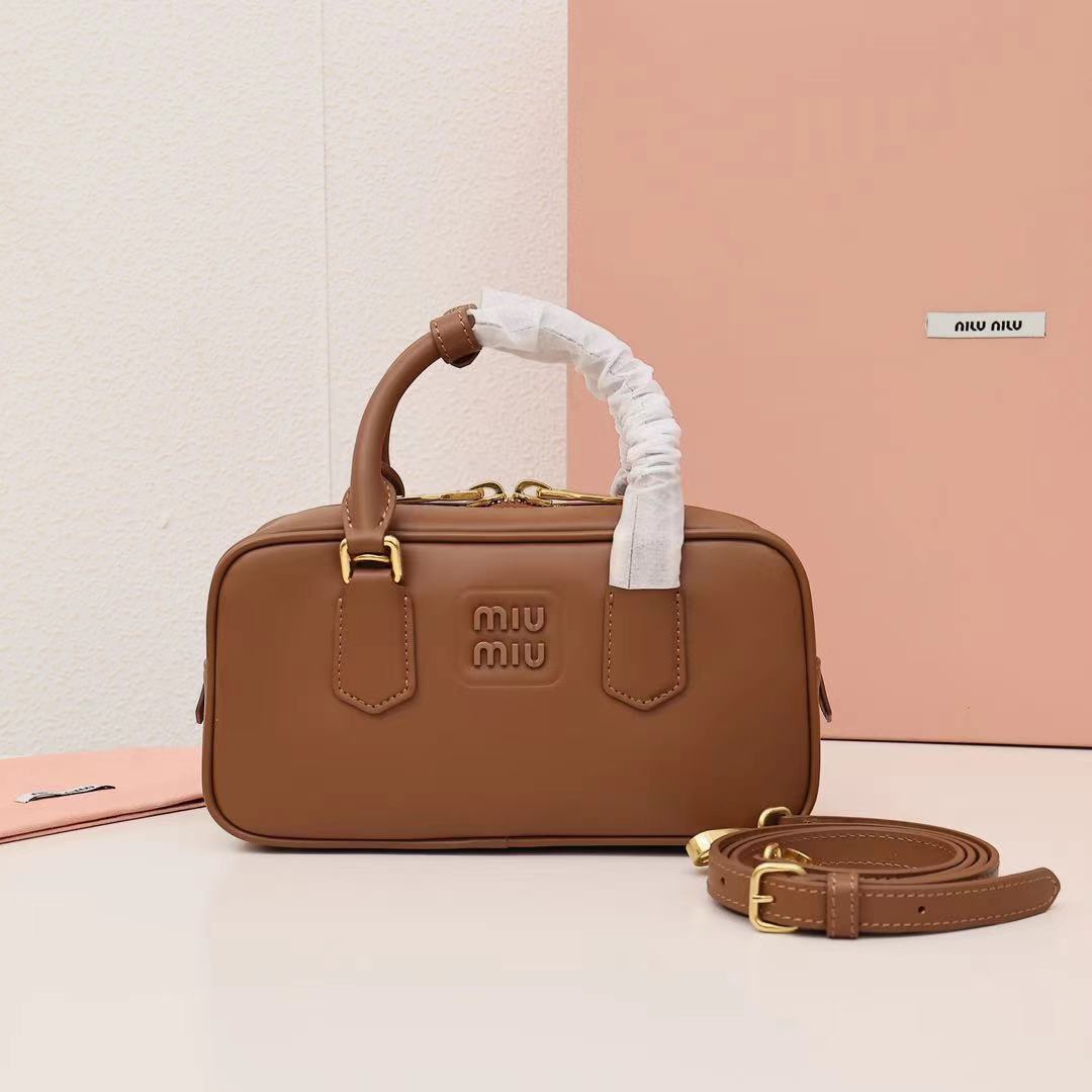 Miumiu bowling bag, versatile and casual, featuring embossed logo and a stylish design. Made of high-quality calf leather, spacious enough for daily use. Simple yet sophisticated, suitable for any style. Size: 22cm. Color: caramel. Comes with original packaging. image 1