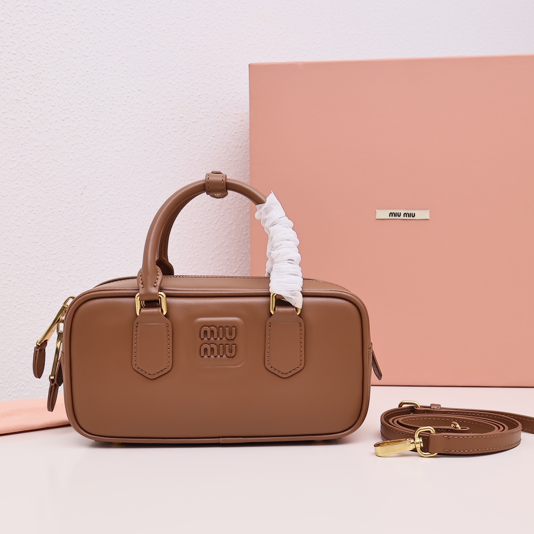 Miumiu bowling bag, versatile and casual, featuring embossed logo, spacious design suitable for various styles. Made of imported cowhide leather. Size: 22cm. Color: Brown. Comes with original packaging. image 1