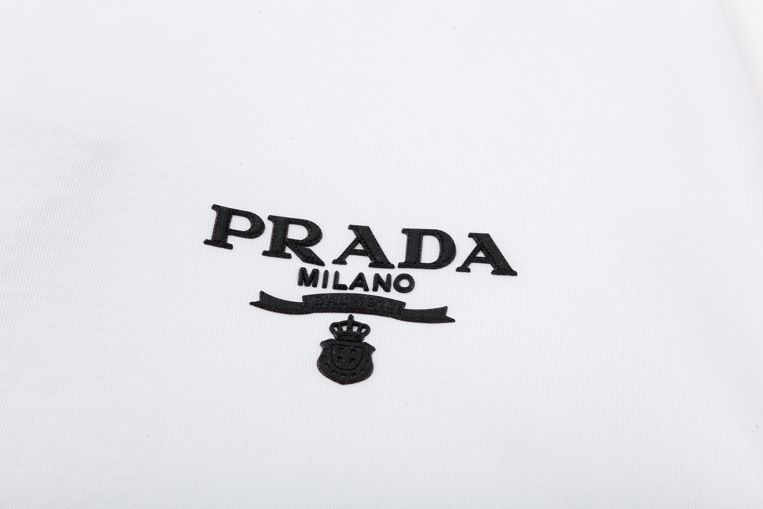 p70
PRADA 普拉达  小字母 立体胶印
升级，灵感源自八十年代复古
原版面料 官方同款  短袖T恤
定制 同缸染面料  手感非常舒服  
春夏最新砖柜同步  时尚又个性 超级百搭好看                
男女都非常合适  人手必备款 
吊牌 领标 水洗麦 三标齐全
颜色: 白色
尺码：S M L XL