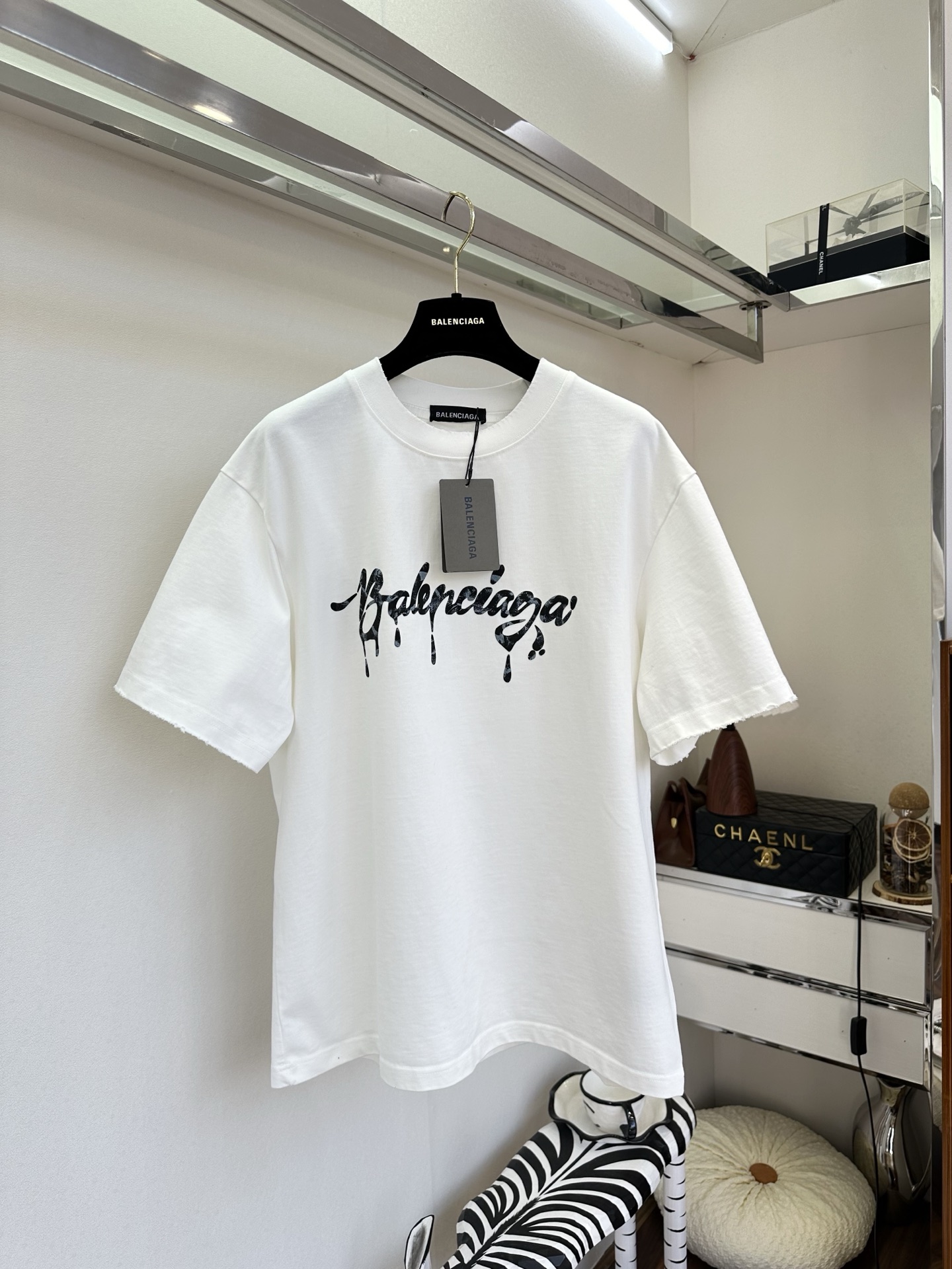 26S B家最新款 简约白T撞上暗黑风泼墨字母，随性又带着点酷感张力。毛边袖口弱化了规整感，松弛感拉满，