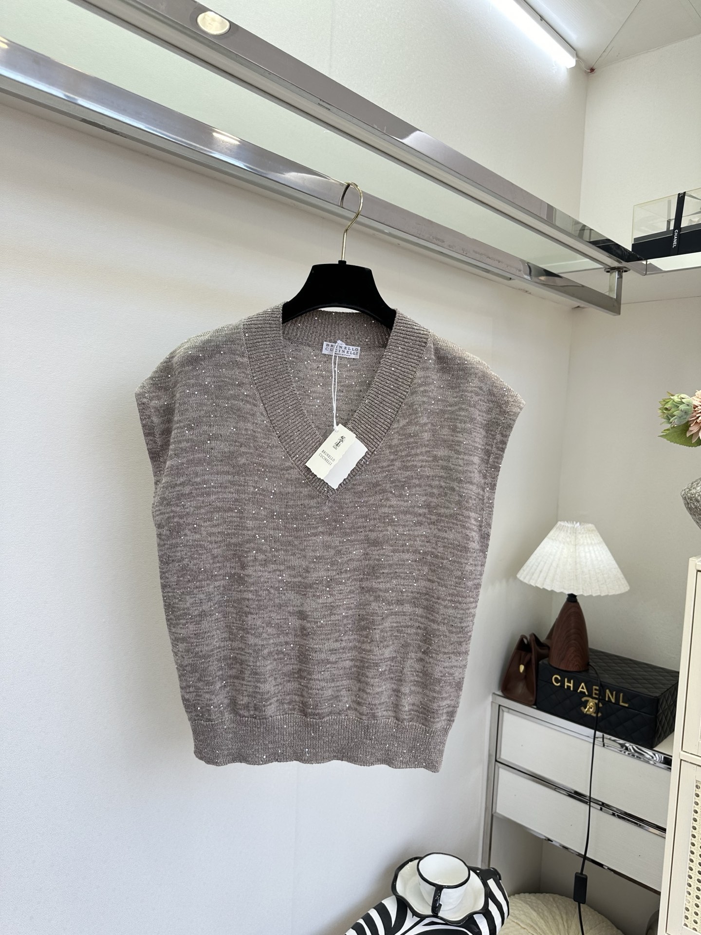 26S 雾感灰棕调自带慵懒滤镜，细碎银闪在针织肌理里轻轻发光。深V领利落修饰肩颈线条，无袖版型轻盈又显瘦