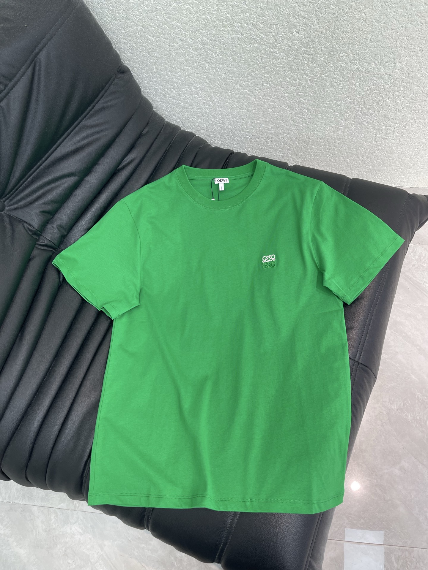 NO:911928,Loew*26 new spring and summer classic color-blocked logo embroidered round neck short-sleeved T-shirt. Bright emerald green with a lively atmosphere, unlocking the refreshing spring and summer style at a glance. The chest is exquisite and three-dimensional  The embroidery is a low-key finishing touch, and the minimalist and redundant design shows the restrained texture of the Spanish luxury brand. The high-count cotton fabric is soft and skin-friendly, and the breathable drape takes into account both comfort and style. It is suitable for single wear and layering. It is unobtrusive but has its own recognition. It is easy to handle low-key and high-end daily relaxed wear. SML,, loewe, T-shirt, tees, t-shirt,19860909Loew*26春夏新款经典拼色logo刺绣圆领短袖T恤 鲜亮翠绿自带鲜活氛围感,一眼解锁春夏清爽格调.胸口精致立体 刺绣低调点睛,极简无冗余设计尽显西班牙奢牌内敛质感.高支棉面料柔软亲肤,透气垂坠兼顾舒适与版型,单穿叠搭皆适配,不张扬却自带辨识度,轻松拿捏低调高级的日常松弛穿搭.SML,,loewe,T-shirt,tees，t-shirt,,Women's clothing