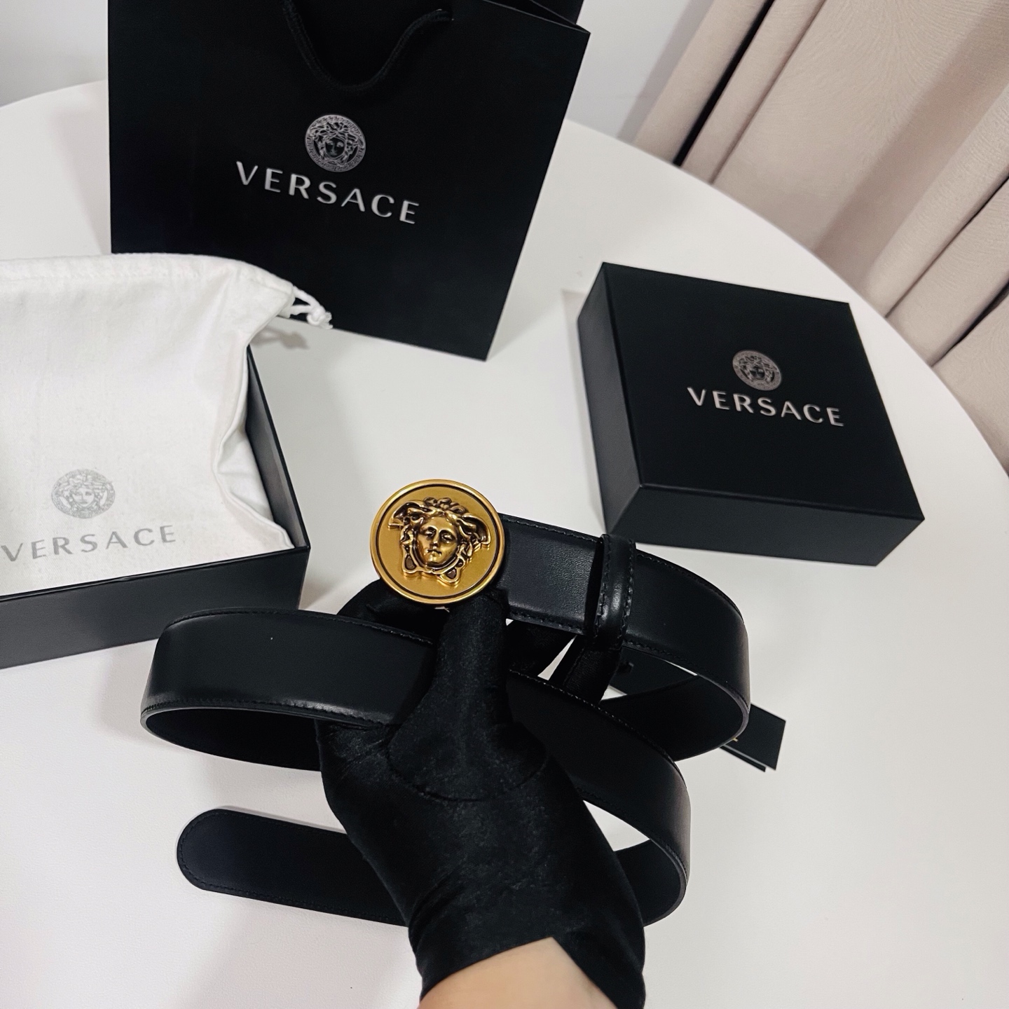 范思哲，新款牛皮革腰带，饰有Versace Logo字样，配有圆形金属搭扣，搭扣采用复古饰面，镶嵌立体M